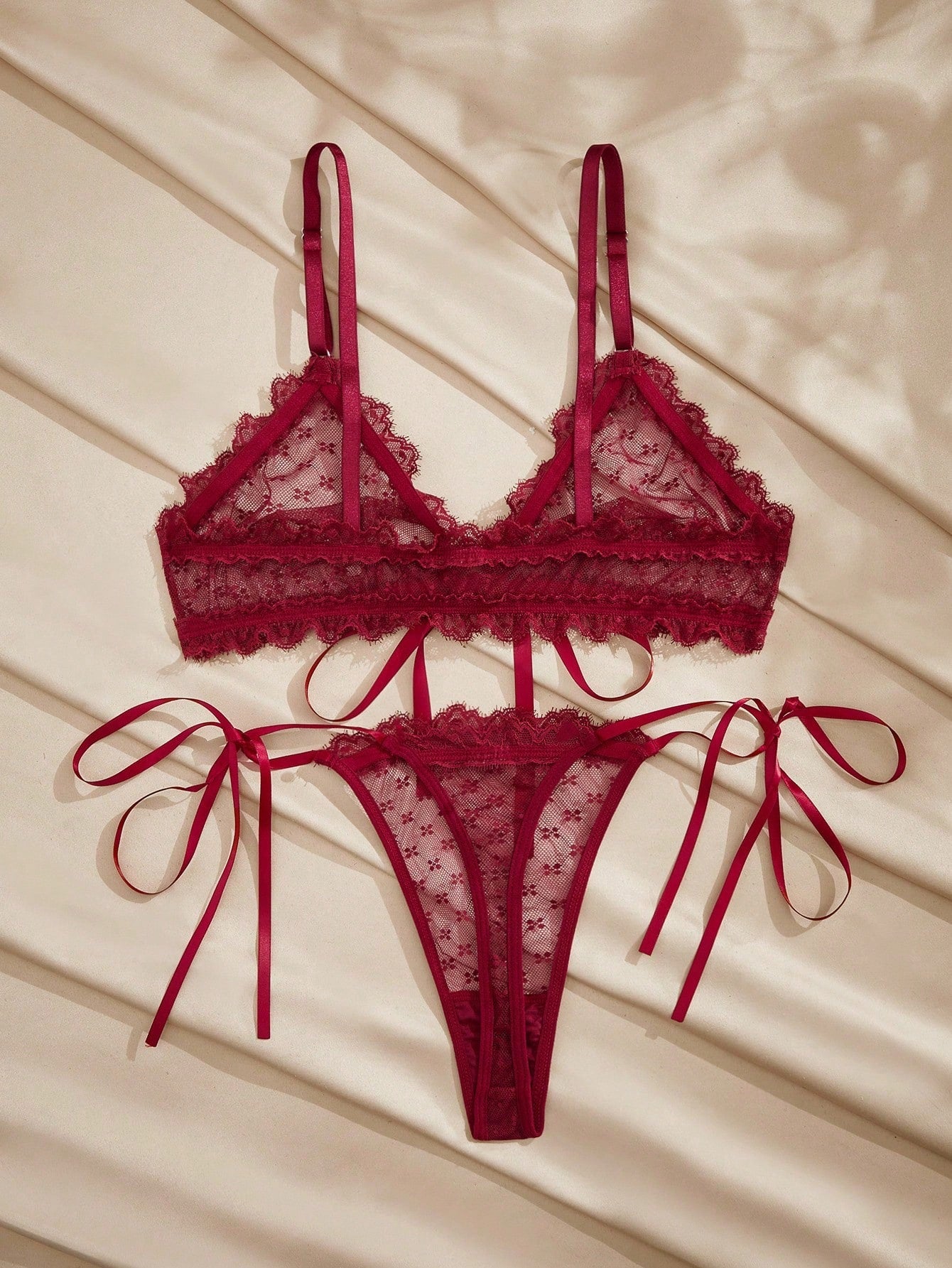 French minimalist 2-piece lingerie set with a sheer wireless bralette featuring contrast lace trim and knot detail, plus a matching mid-rise thong with medium-stretch fabric and adjustable straps.
