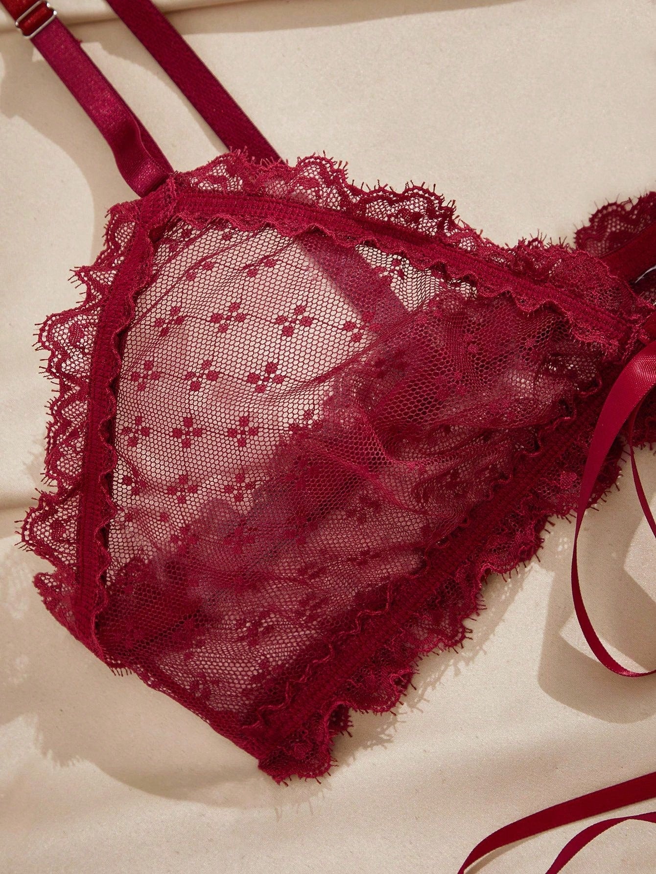 French minimalist 2-piece lingerie set with a sheer wireless bralette featuring contrast lace trim and knot detail, plus a matching mid-rise thong with medium-stretch fabric and adjustable straps.