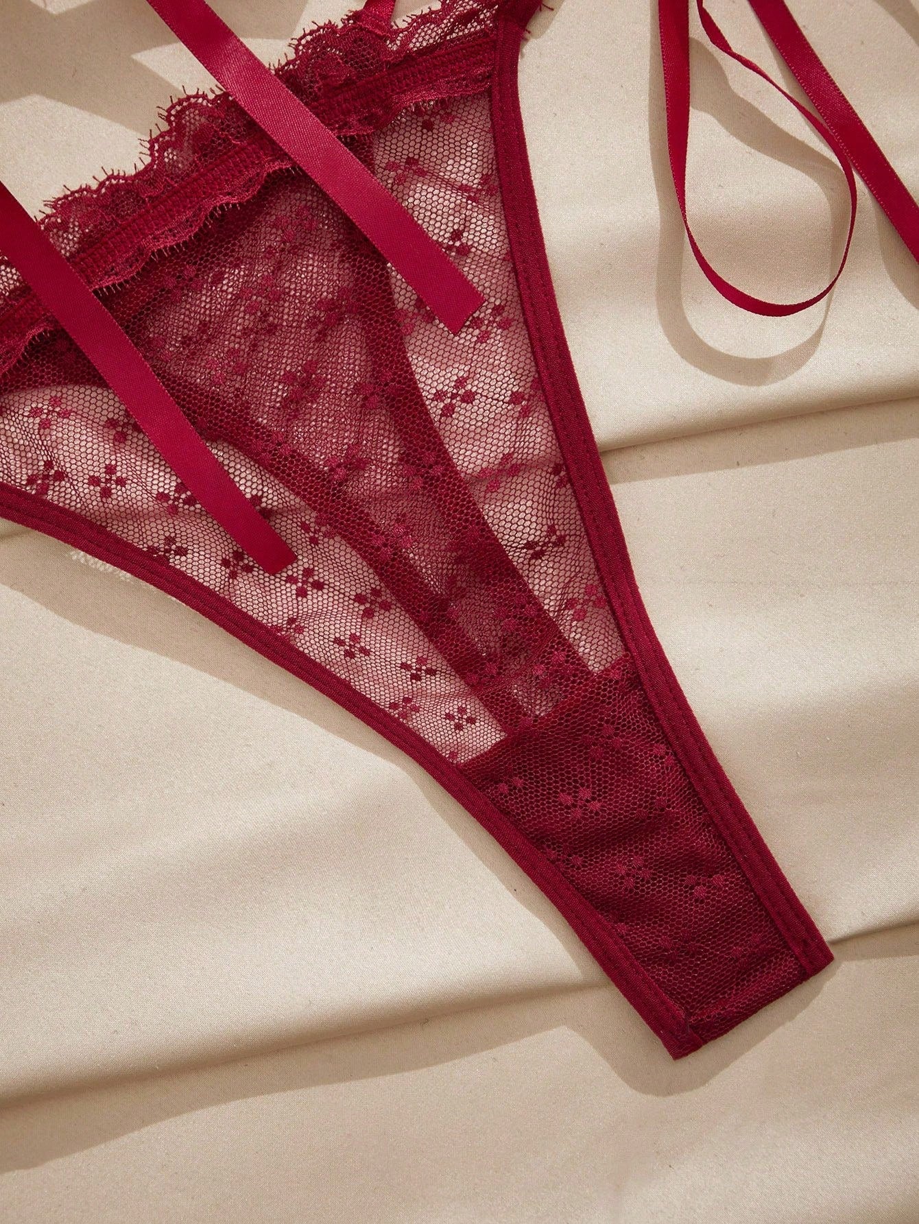French minimalist 2-piece lingerie set with a sheer wireless bralette featuring contrast lace trim and knot detail, plus a matching mid-rise thong with medium-stretch fabric and adjustable straps.