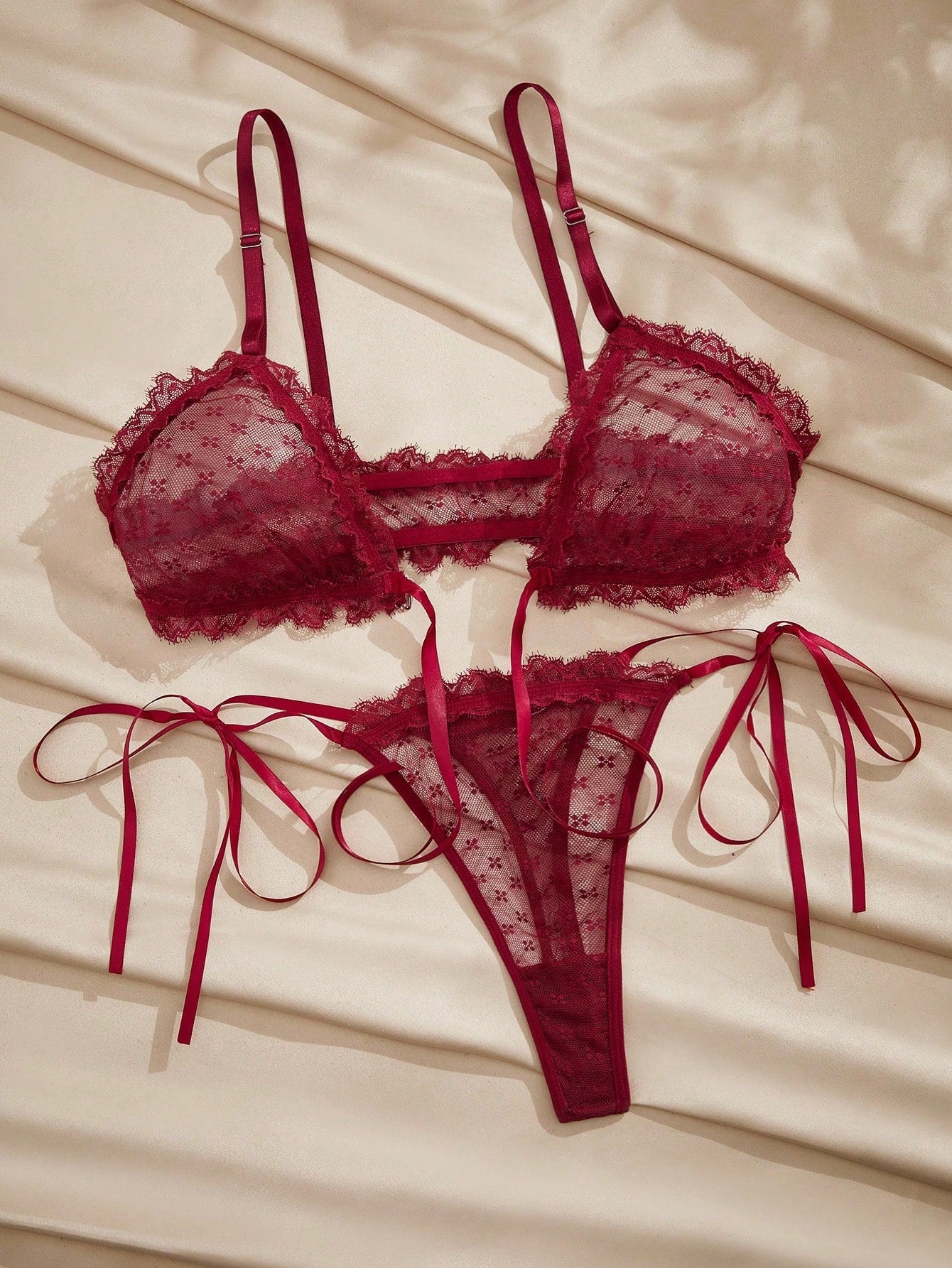 French minimalist 2-piece lingerie set with a sheer wireless bralette featuring contrast lace trim and knot detail, plus a matching mid-rise thong with medium-stretch fabric and adjustable straps.