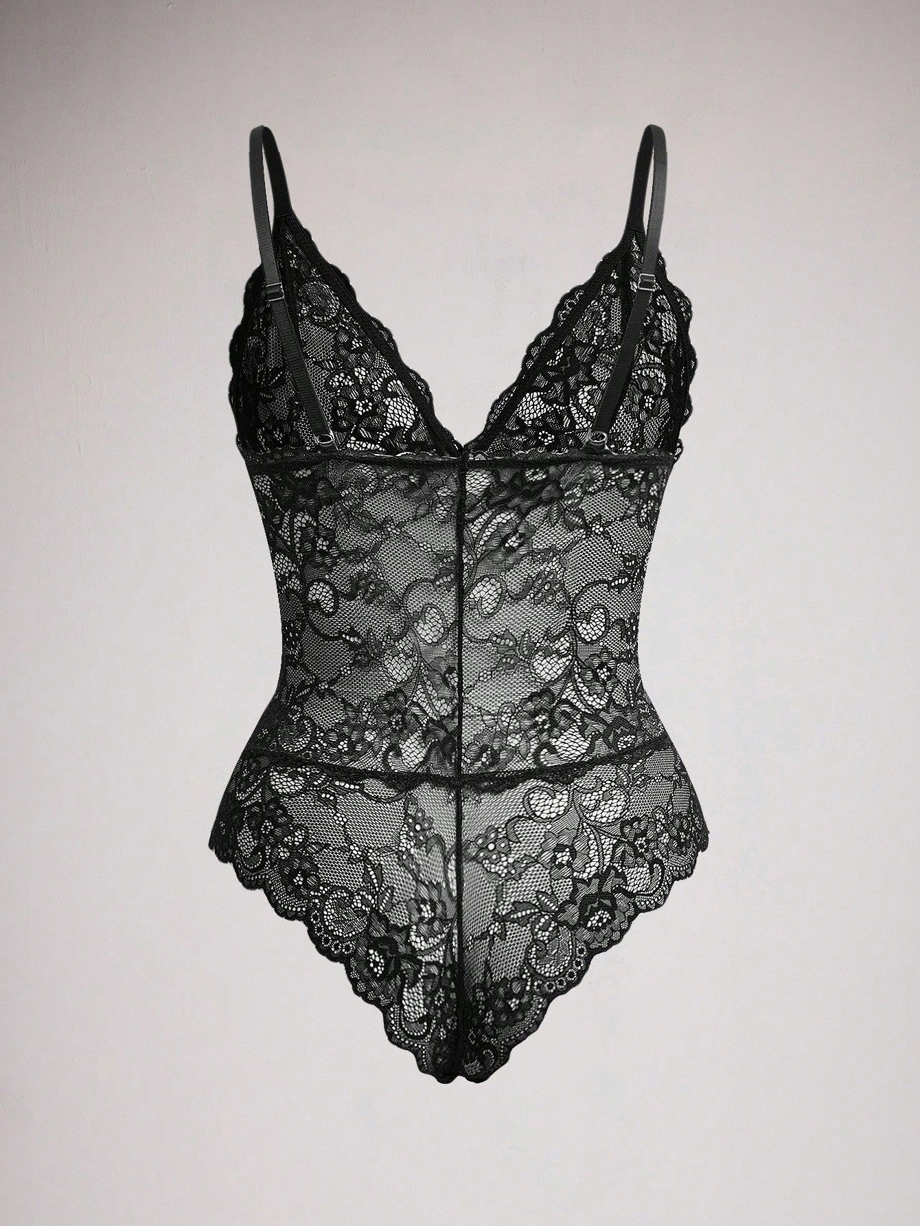 Women's black lace bodysuit with sheer contrast lace, backless design, spaghetti straps, and adjustable straps