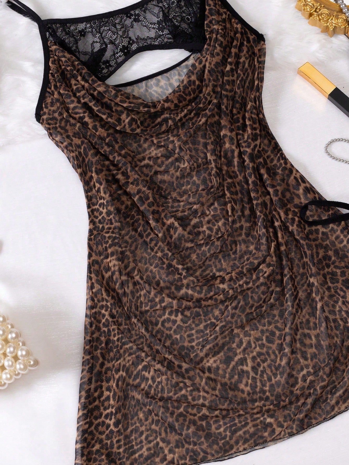 2-piece leopard print lingerie set featuring a hollow-out cami-style short nightgown with adjustable spaghetti straps and a matching low-rise V-string panty.