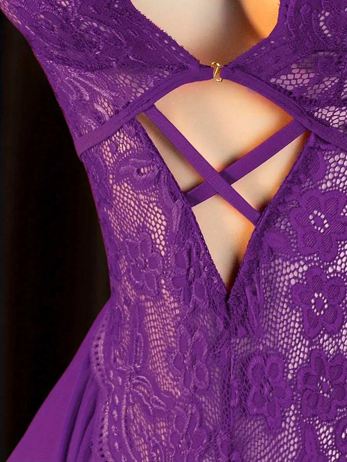 Women’s sexy lingerie bodysuit featuring an off-shoulder look, hollow-out detailing, contrast lace, sheer fabric, bow accent, halter neckline, and adjustable straps.