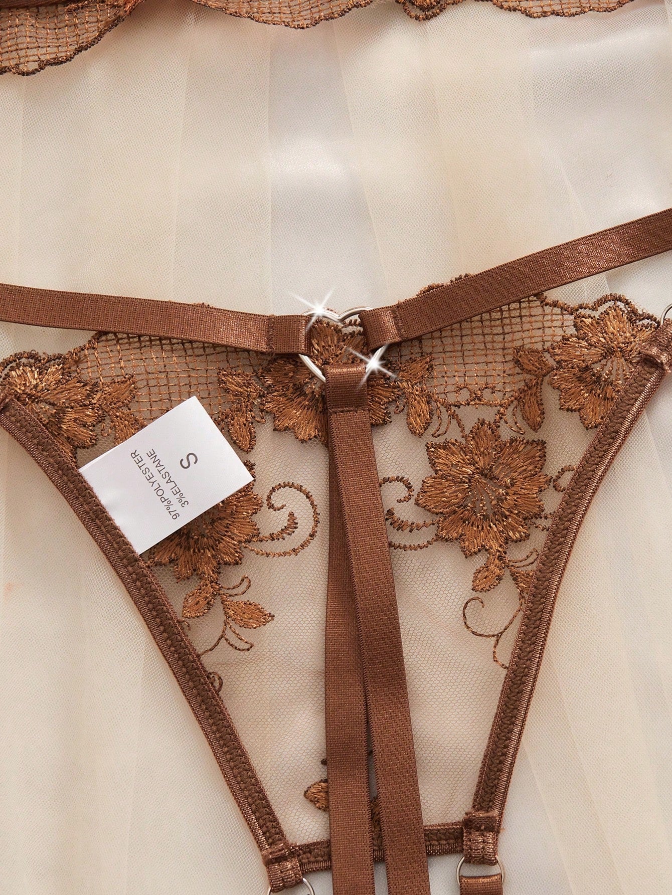 Two-piece women’s lingerie set with embroidered sheer fabric, hollow-out cutout details, underwire demi bra with adjustable spaghetti straps, and matching low-rise thong.
