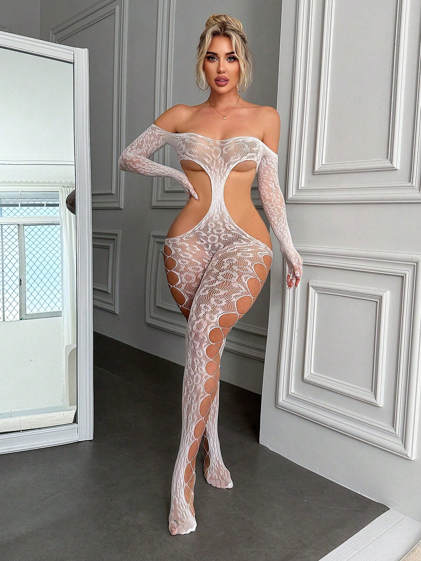 White women’s lace and mesh off-shoulder jumpsuit bodysuit with hollow-out all-over pattern, adjustable straps, sleeveless design, and sheer high-stretch fabric.