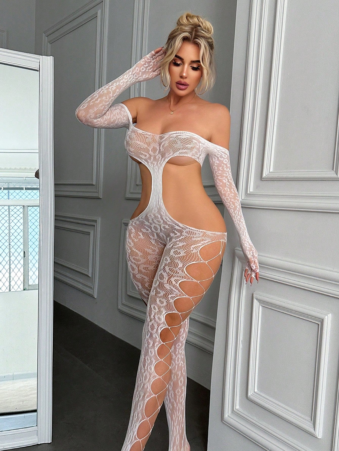 White women’s lace and mesh off-shoulder jumpsuit bodysuit with hollow-out all-over pattern, adjustable straps, sleeveless design, and sheer high-stretch fabric.