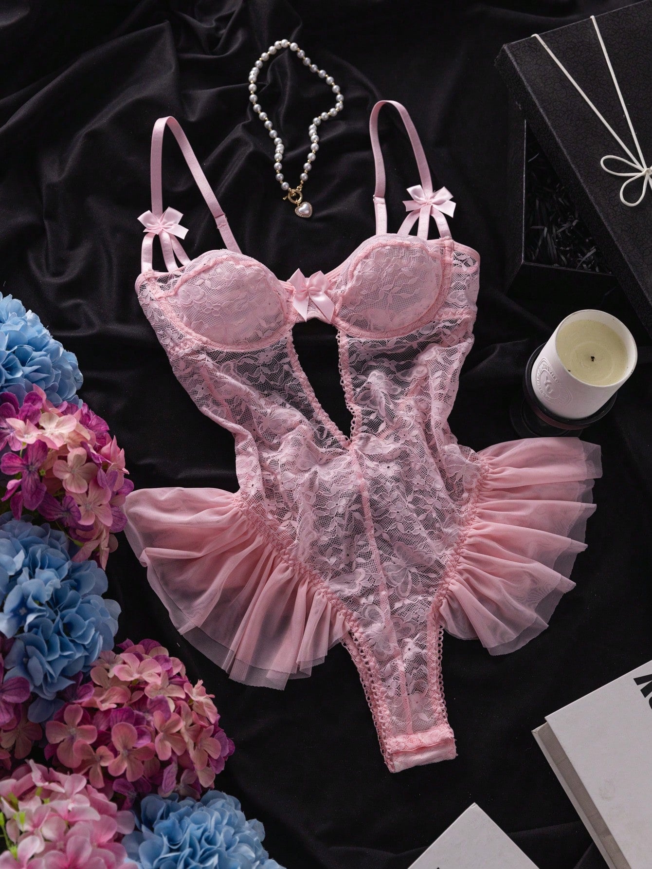 Women’s butterfly lace and mesh lingerie jumpsuit with ruffled trim, underwire cups, bow detail, cut-out accents, sheer fabric, and adjustable spaghetti straps.