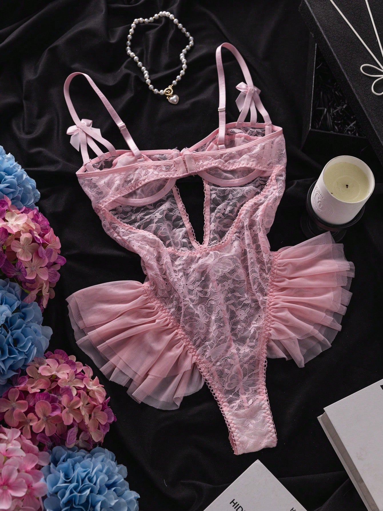 Women’s butterfly lace and mesh lingerie jumpsuit with ruffled trim, underwire cups, bow detail, cut-out accents, sheer fabric, and adjustable spaghetti straps.