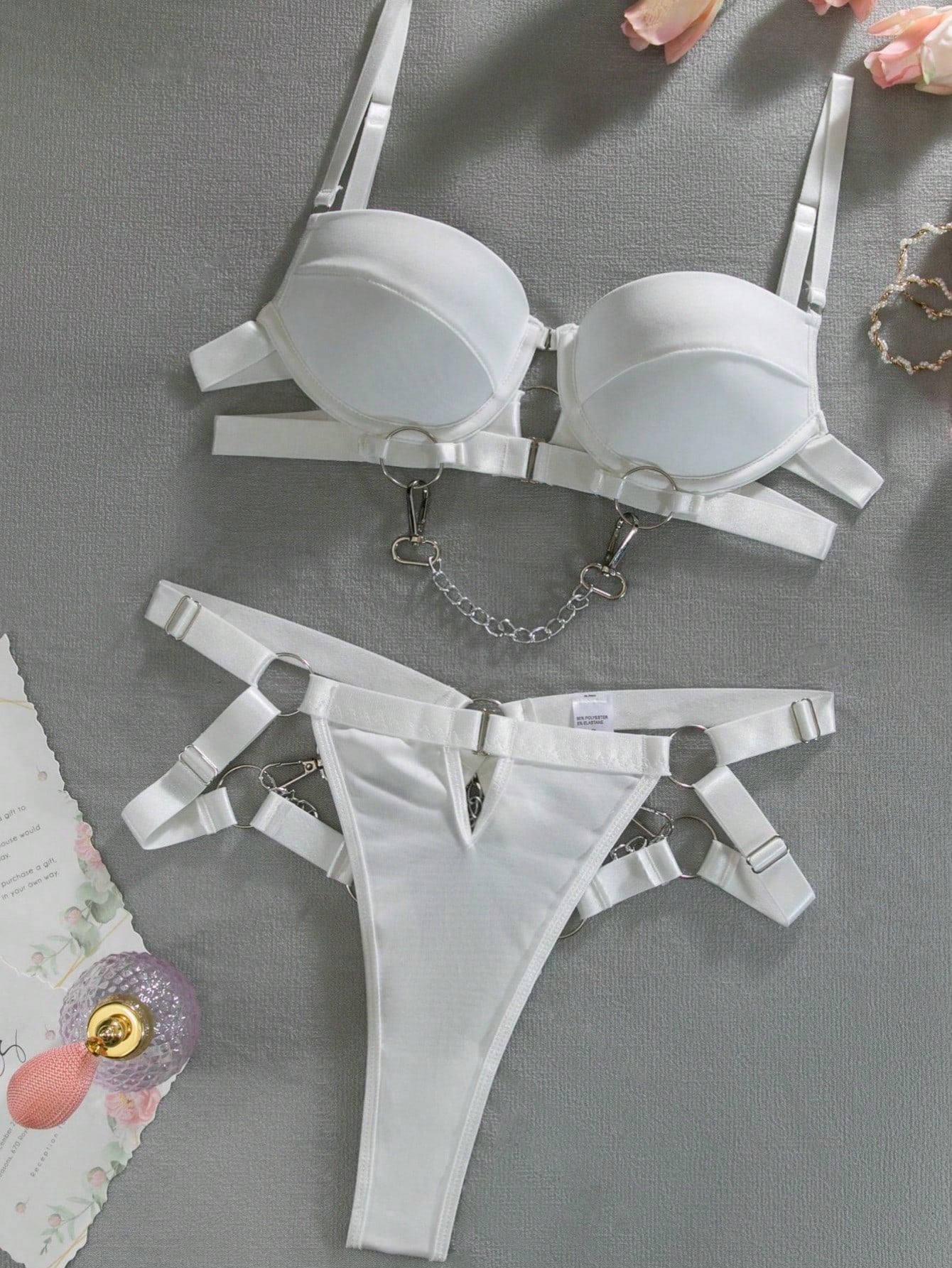 White tie-dye 2-piece backless lingerie set with spaghetti straps, cut-out ring and chain details, and mid-rise crotchless brief panties.