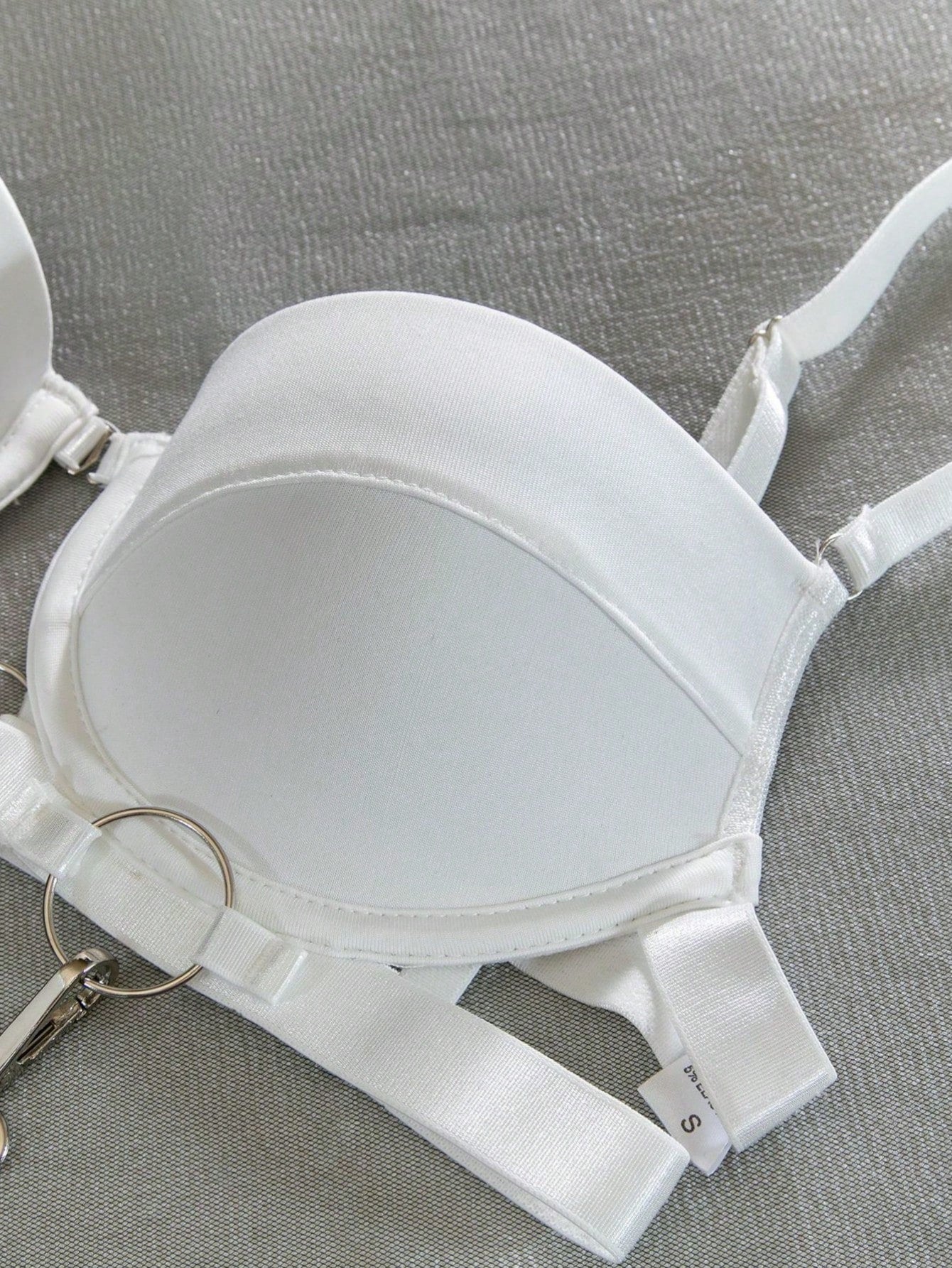 White tie-dye 2-piece backless lingerie set with spaghetti straps, cut-out ring and chain details, and mid-rise crotchless brief panties.