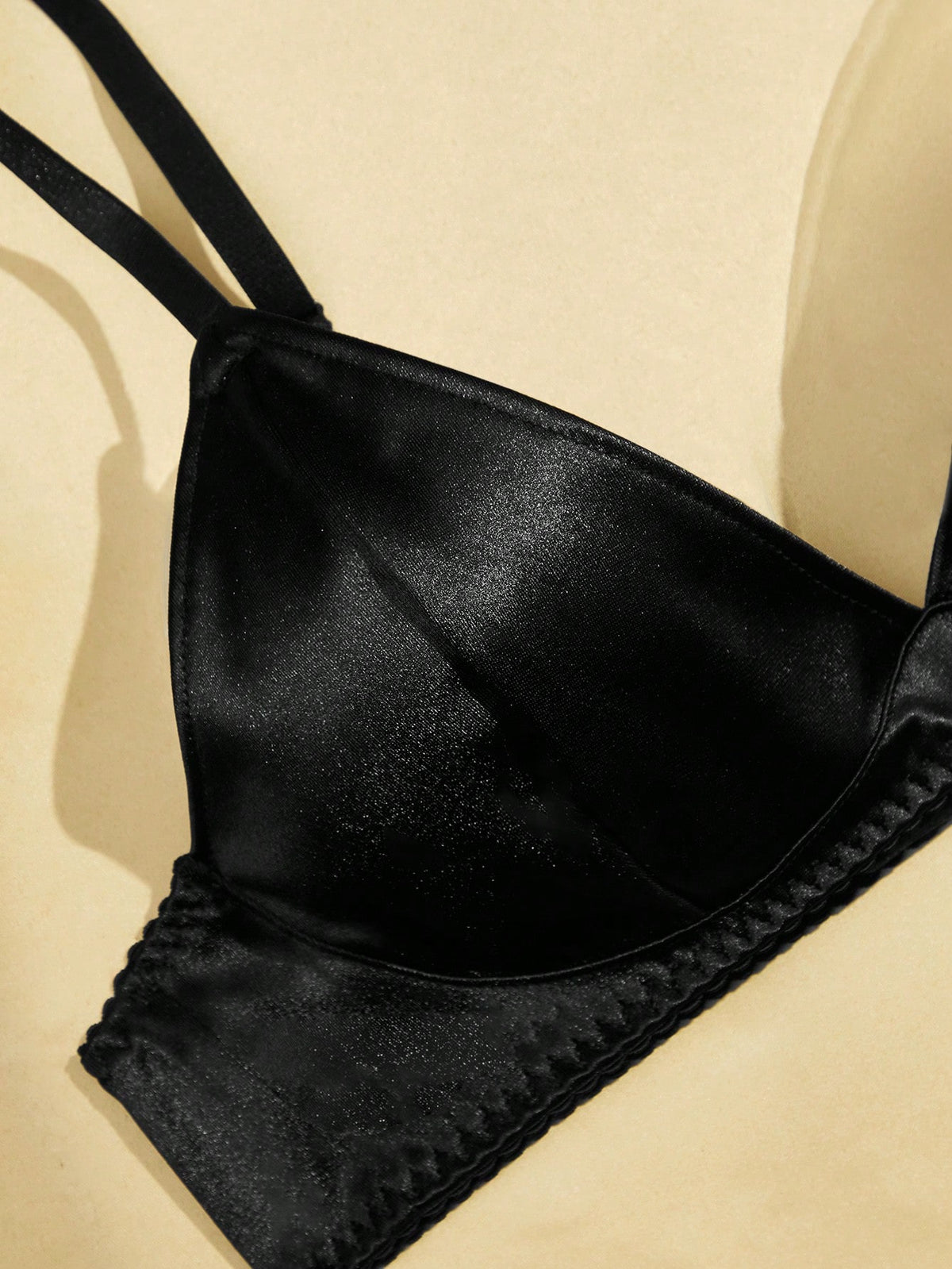 Black 2-piece lingerie set with a wireless bralette featuring adjustable straps and matching low-rise thong
