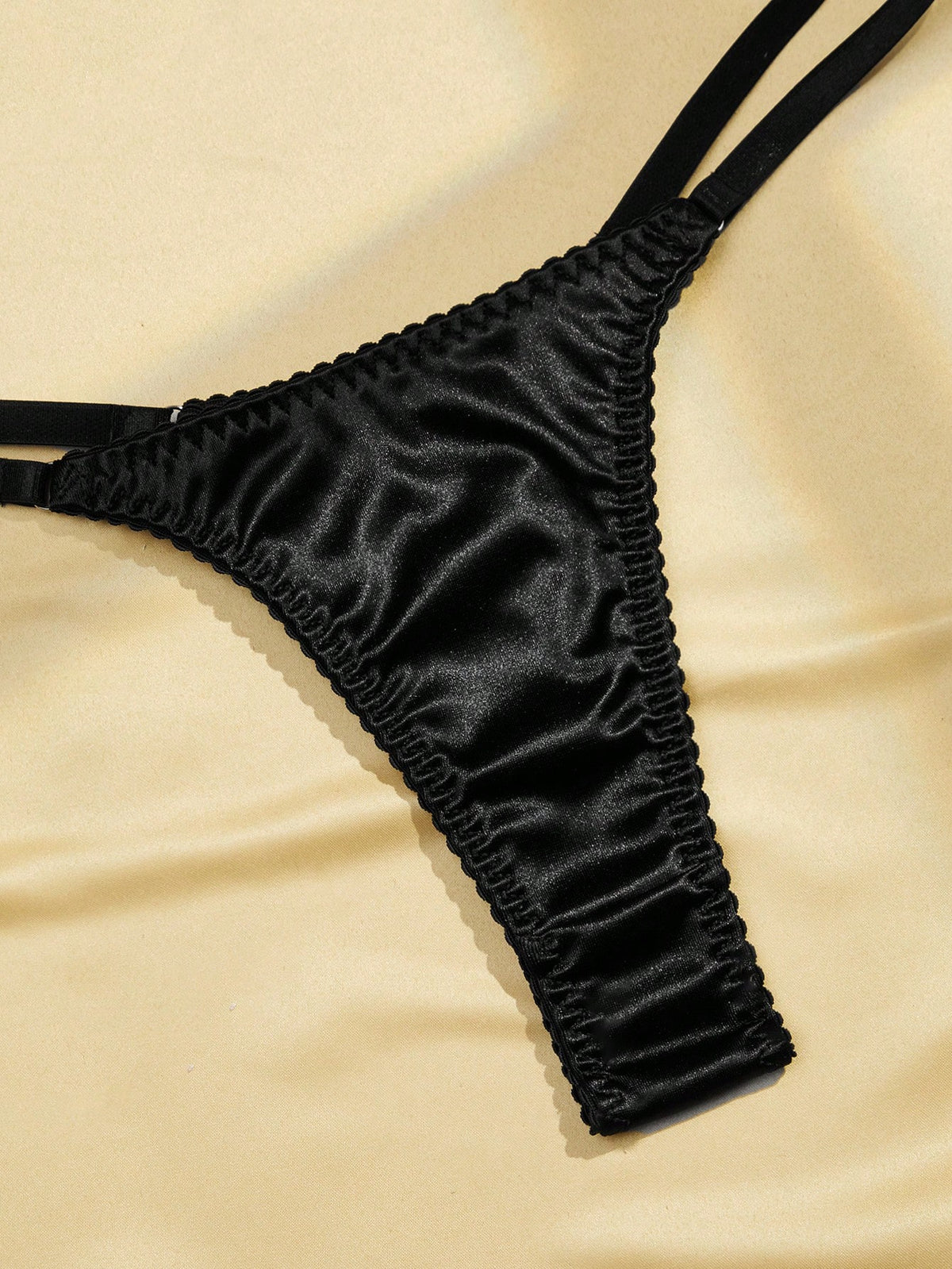 Black 2-piece lingerie set with a wireless bralette featuring adjustable straps and matching low-rise thong