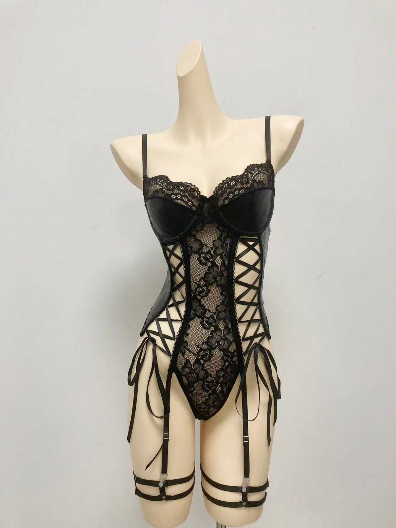 Three-piece women's goth lace bodysuit lingerie set featuring contrast lace, cut-out and lace-up details, spaghetti straps, underwire 1/2 cup, and matching high-rise thong bottoms.