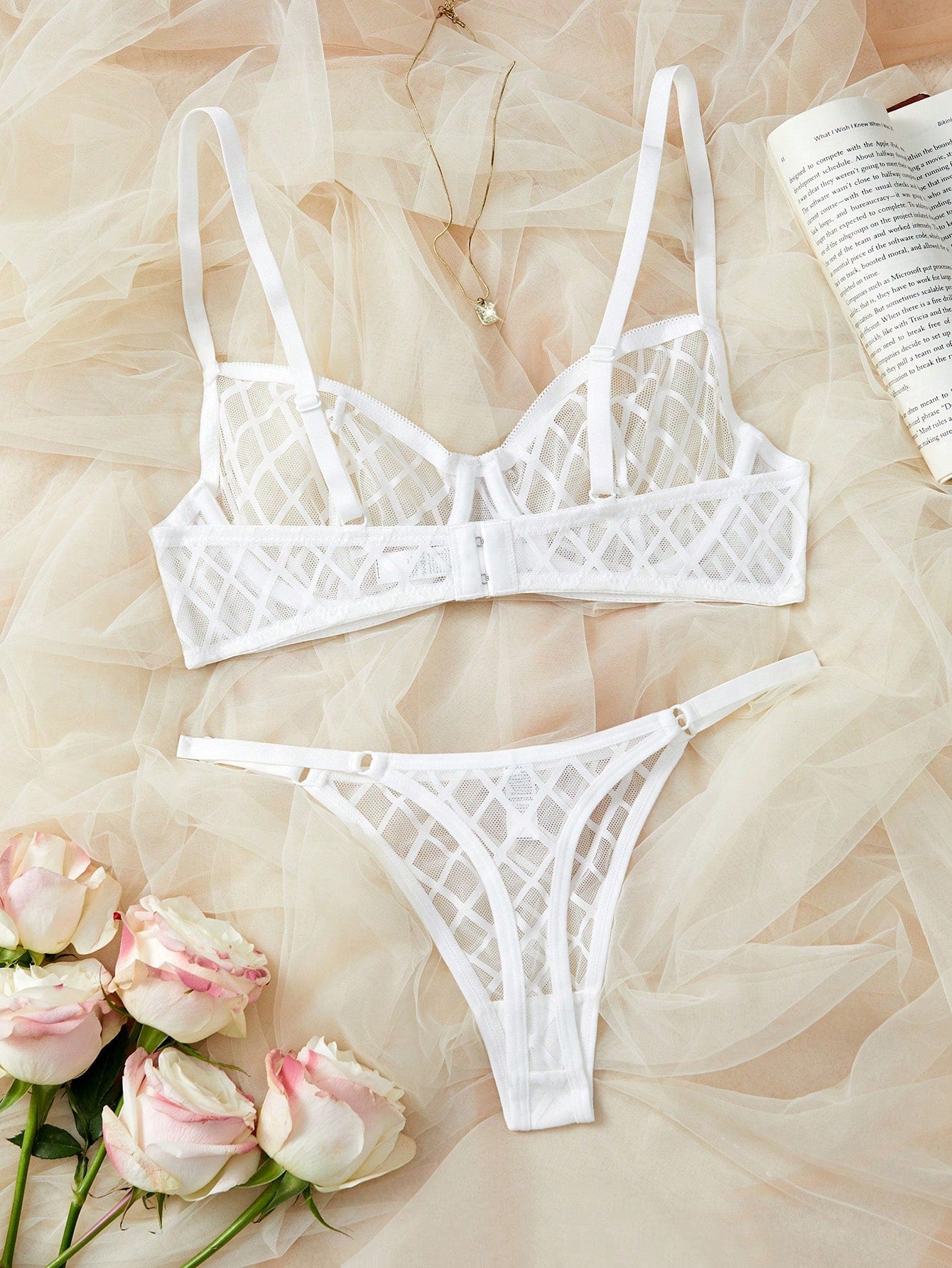 Two-piece sheer mesh lingerie set featuring a balconette bra and matching low-rise thong, with cut-out detailing and adjustable straps in a minimalist romantic style.