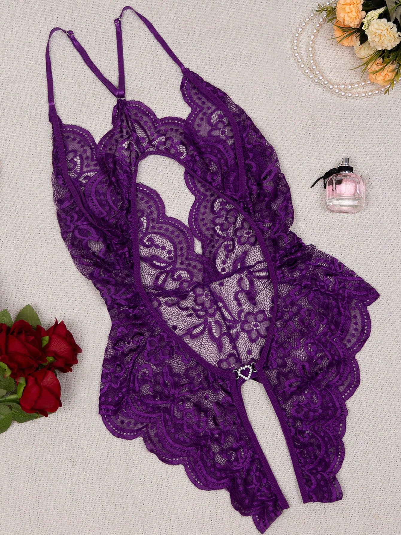 Women’s 1-piece crotchless lace teddy lingerie with a backless design, bowknot detail, open cup, scallop lace trim, spaghetti straps, and crossback straps; semi-sheer, wireless, sleeveless style.