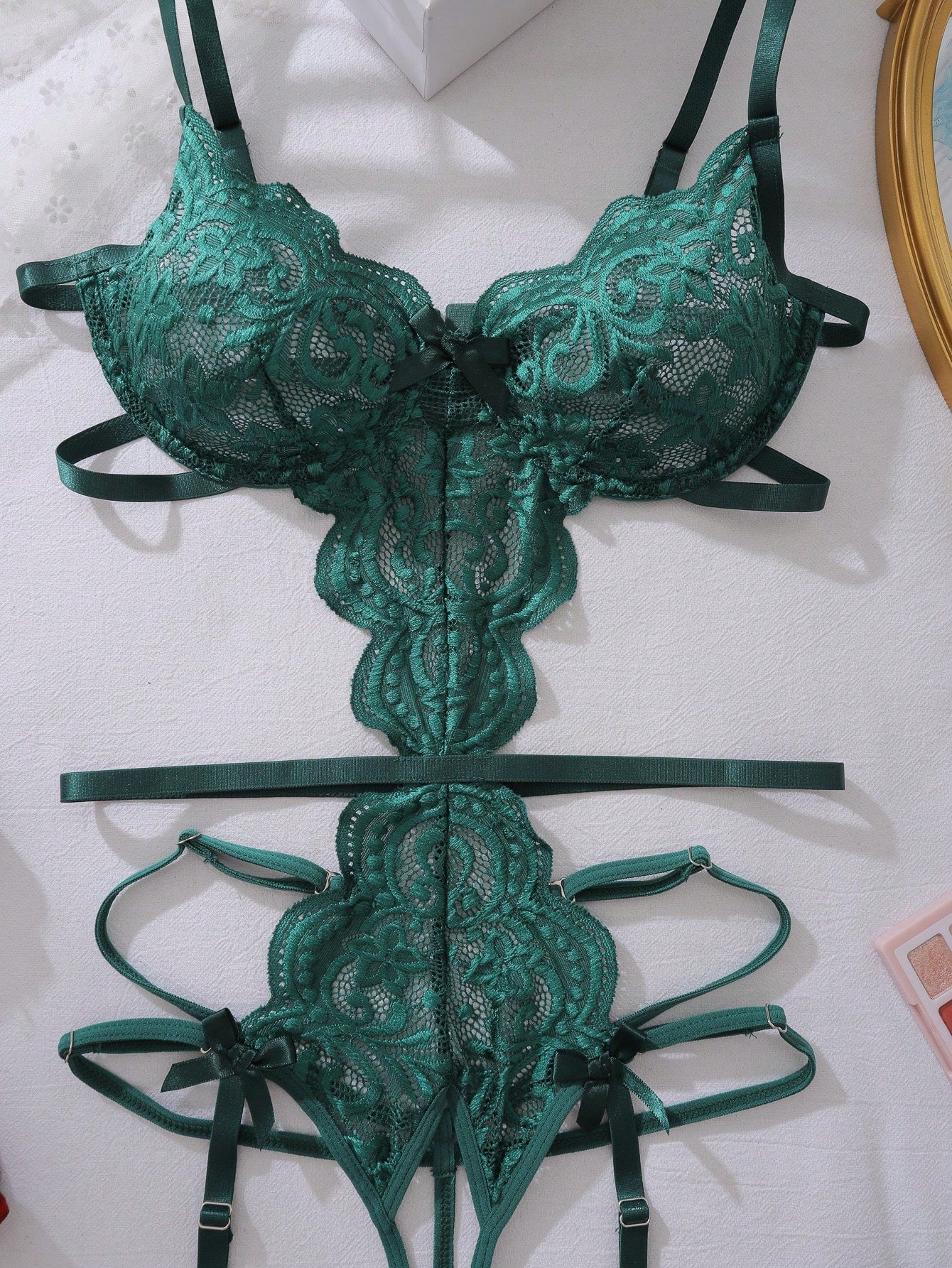 Dark green floral lace backless teddy bodysuit lingerie with sheer unlined fabric, scalloped trim, cut-out details, adjustable spaghetti straps, triangle cups, wireless bralette style, high-rise V-string design, and removable padding.