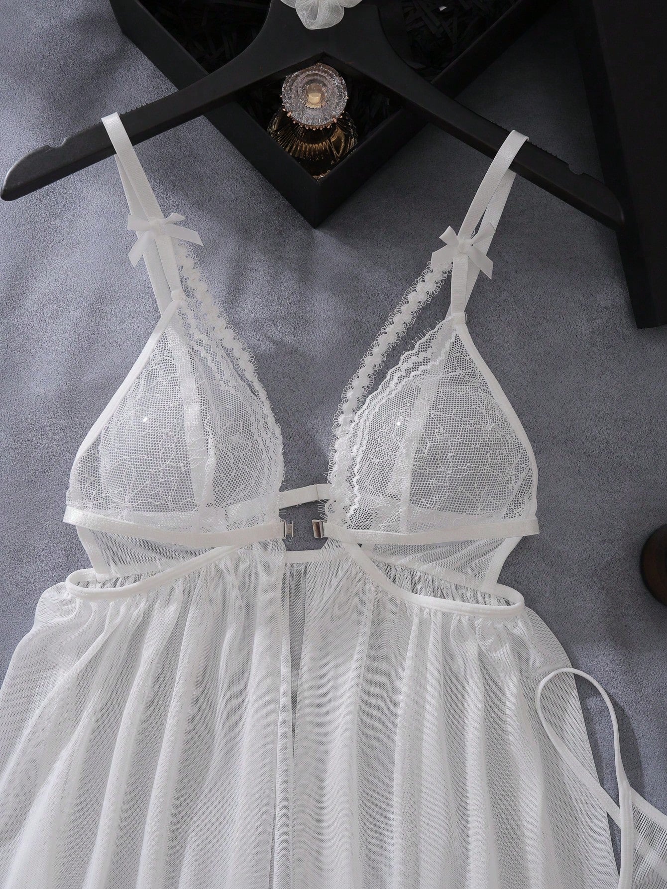 Women’s 2-piece lingerie set featuring a romantic lace patchwork babydoll nightgown with spaghetti straps, bow and cut-out details, and a matching low-rise thong.
