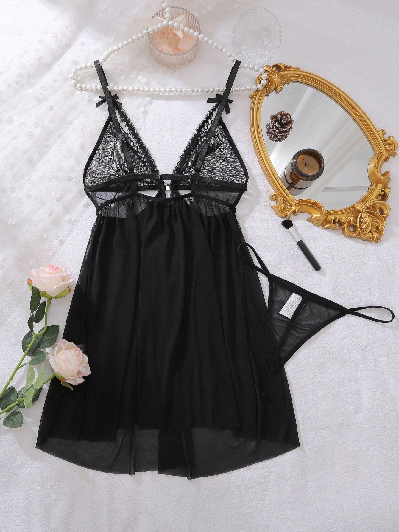 Women’s 2-piece lingerie set featuring a romantic lace patchwork babydoll nightgown with spaghetti straps, bow and cut-out details, and a matching low-rise thong.