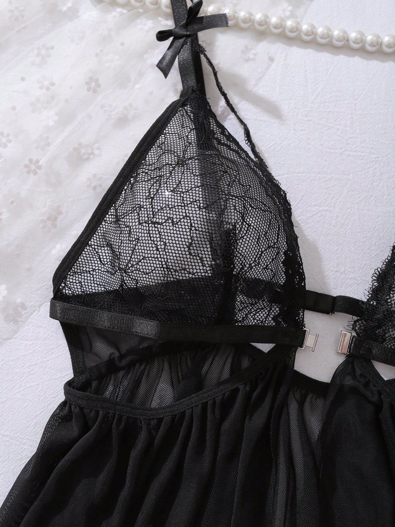 Women’s 2-piece lingerie set featuring a romantic lace patchwork babydoll nightgown with spaghetti straps, bow and cut-out details, and a matching low-rise thong.
