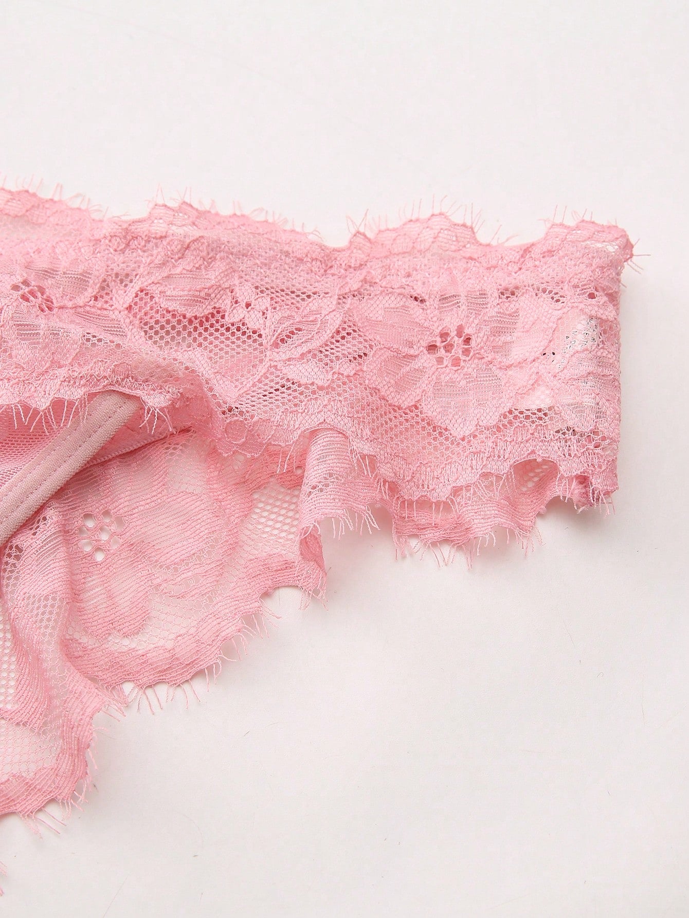 Women's low-rise lace mesh trim thong panties with sheer detailing, bow and knot accents, and plant pattern