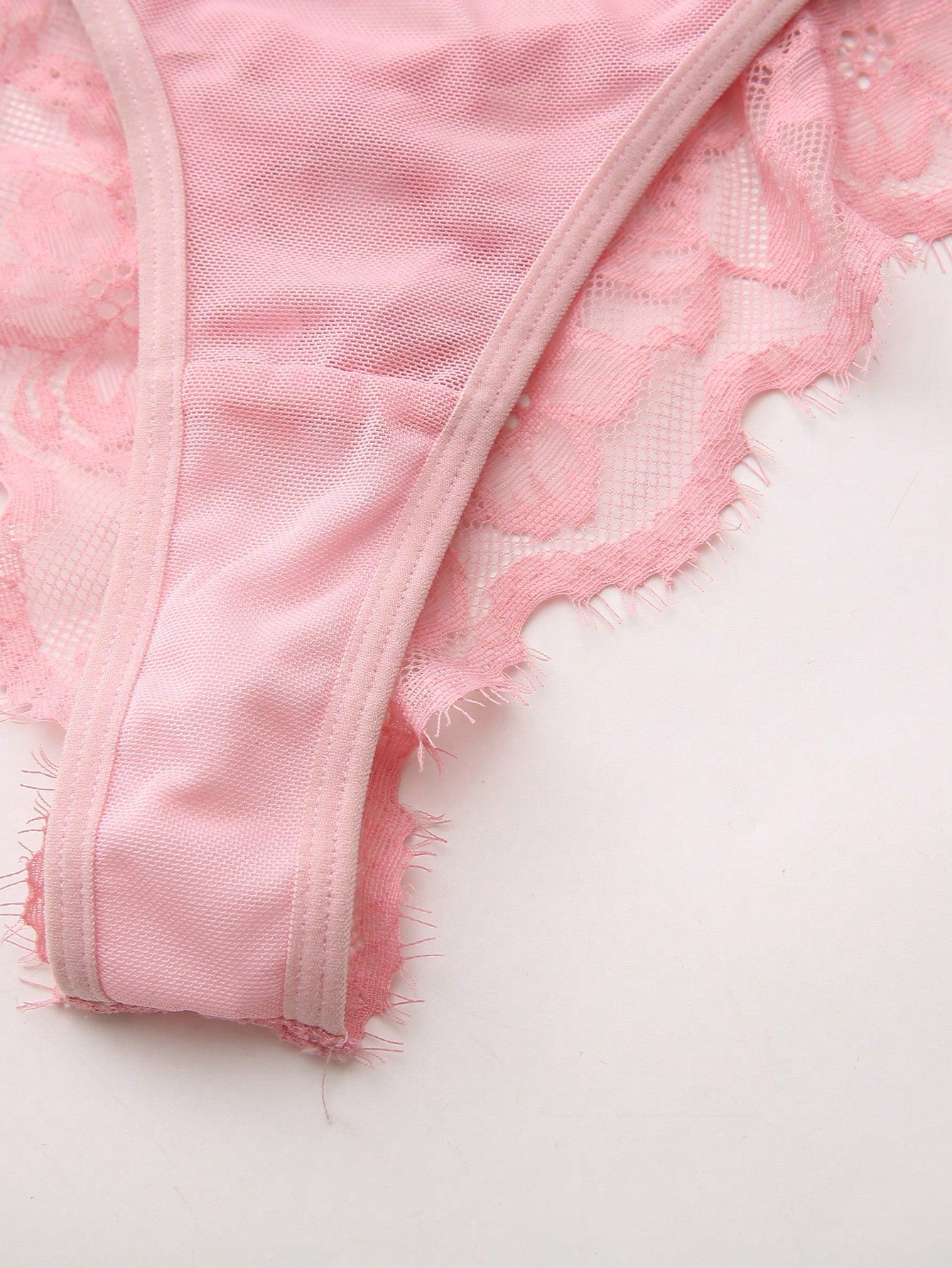 Women's low-rise lace mesh trim thong panties with sheer detailing, bow and knot accents, and plant pattern