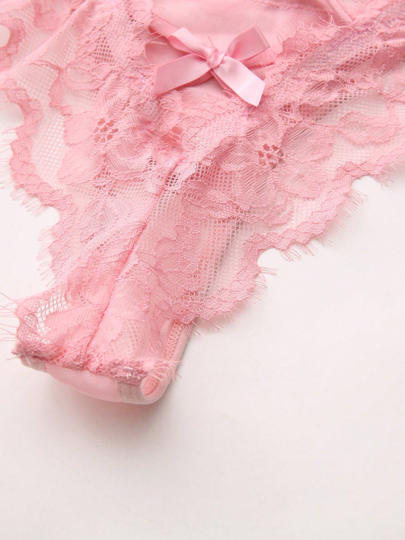 Women's low-rise lace mesh trim thong panties with sheer detailing, bow and knot accents, and plant pattern