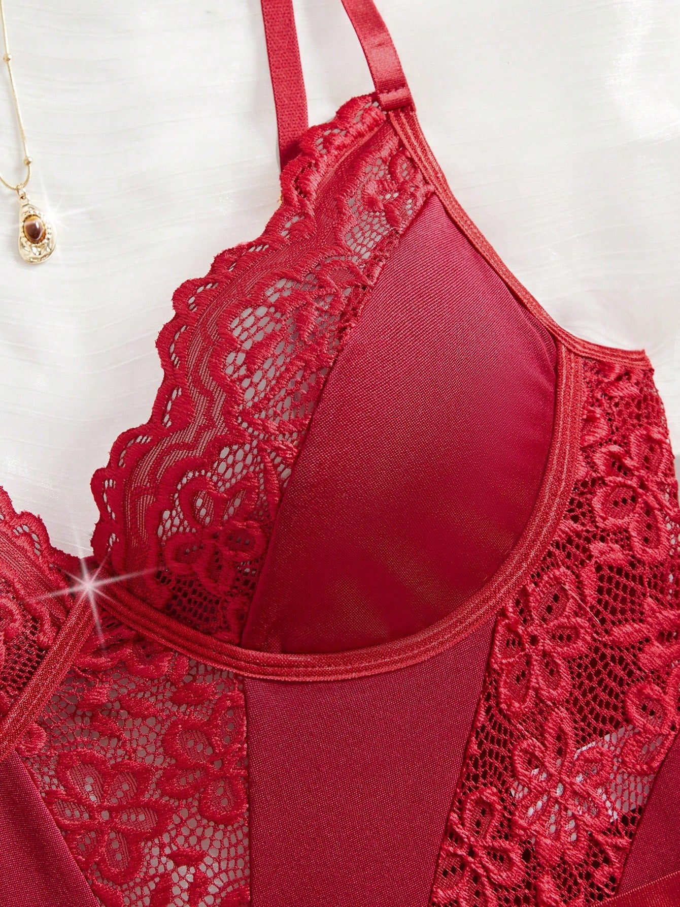 Women’s 2-piece sexy lace patch bodysuit set featuring adjustable spaghetti straps, cut-out details, semi-sheer fabric, and thong-style bottoms.