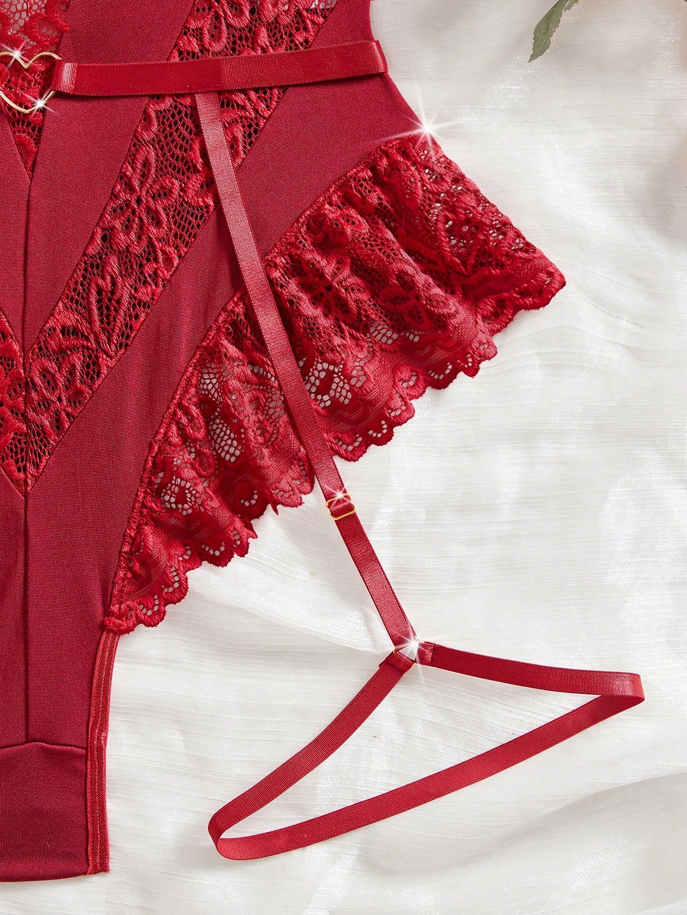 Women’s 2-piece sexy lace patch bodysuit set featuring adjustable spaghetti straps, cut-out details, semi-sheer fabric, and thong-style bottoms.