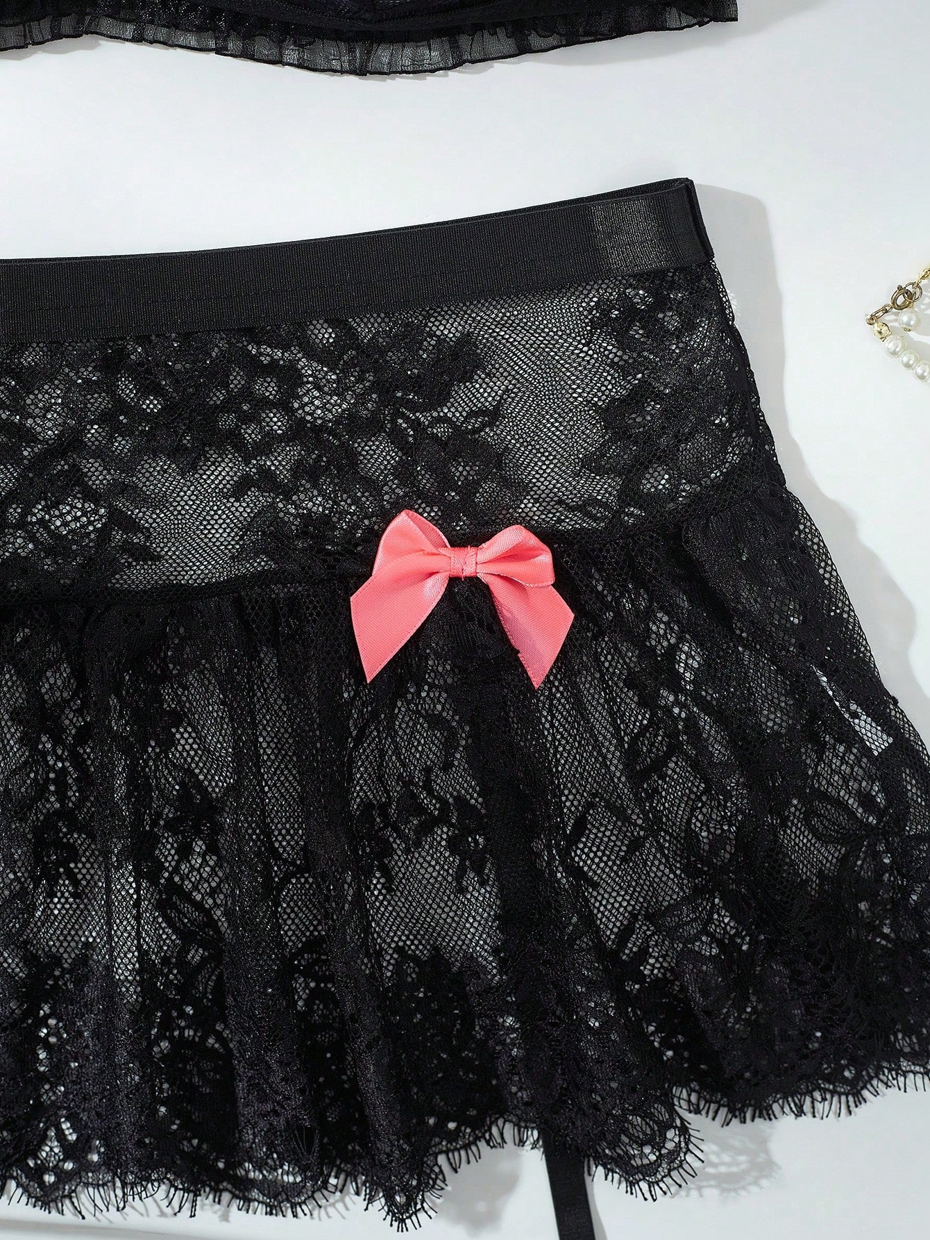 Women’s 5-piece romantic lace lingerie set featuring a sheer bralette with adjustable spaghetti straps, mini skirt, thong, and stockings with contrast lace and bow details.