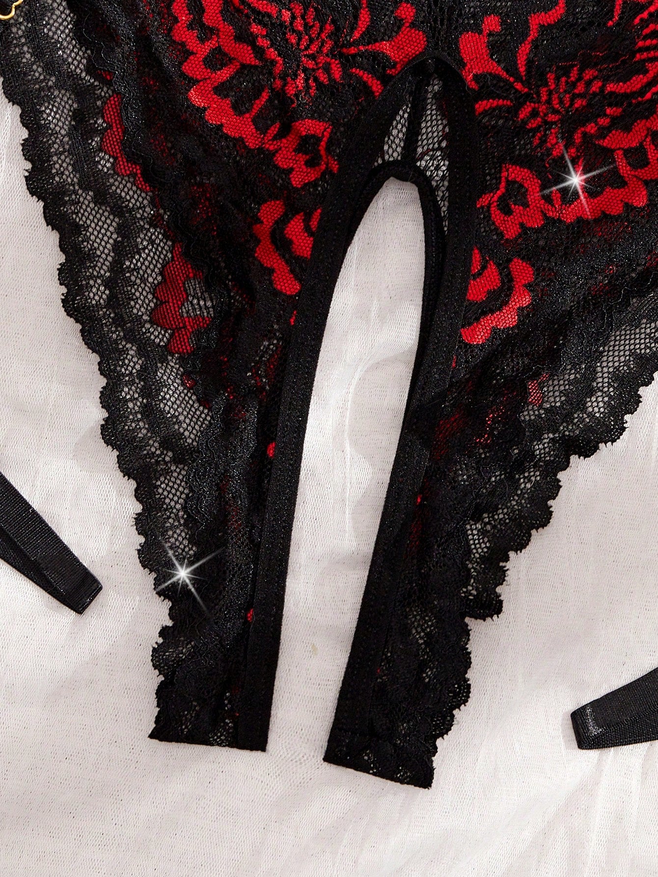 Two-piece women’s sexy lace bodysuit set with contrast lace, cut-out details, crossback spaghetti straps, and thong-style bottoms; wireless design with slight stretch, shown in multicolor with plant/random print accents.