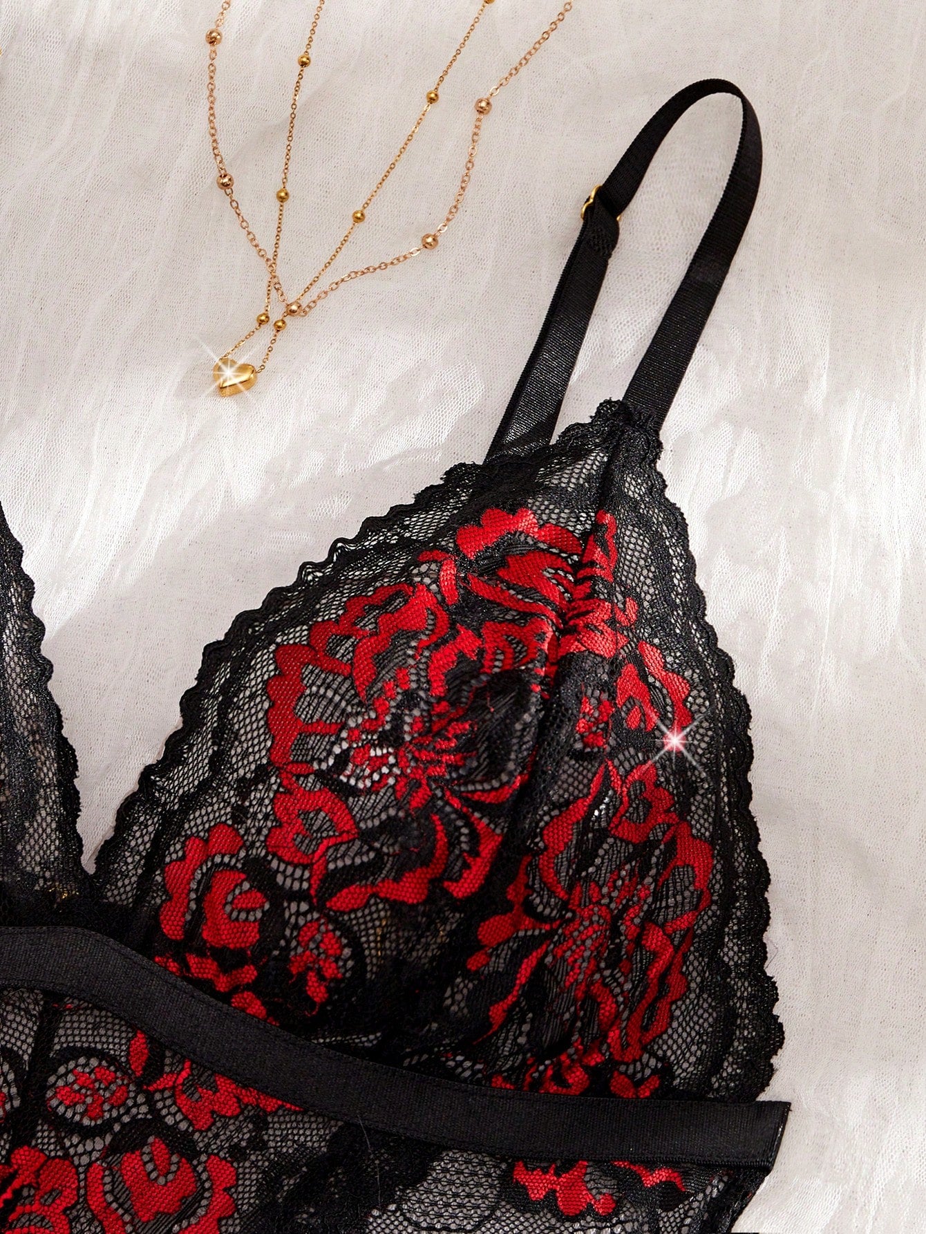 Two-piece women’s sexy lace bodysuit set with contrast lace, cut-out details, crossback spaghetti straps, and thong-style bottoms; wireless design with slight stretch, shown in multicolor with plant/random print accents.