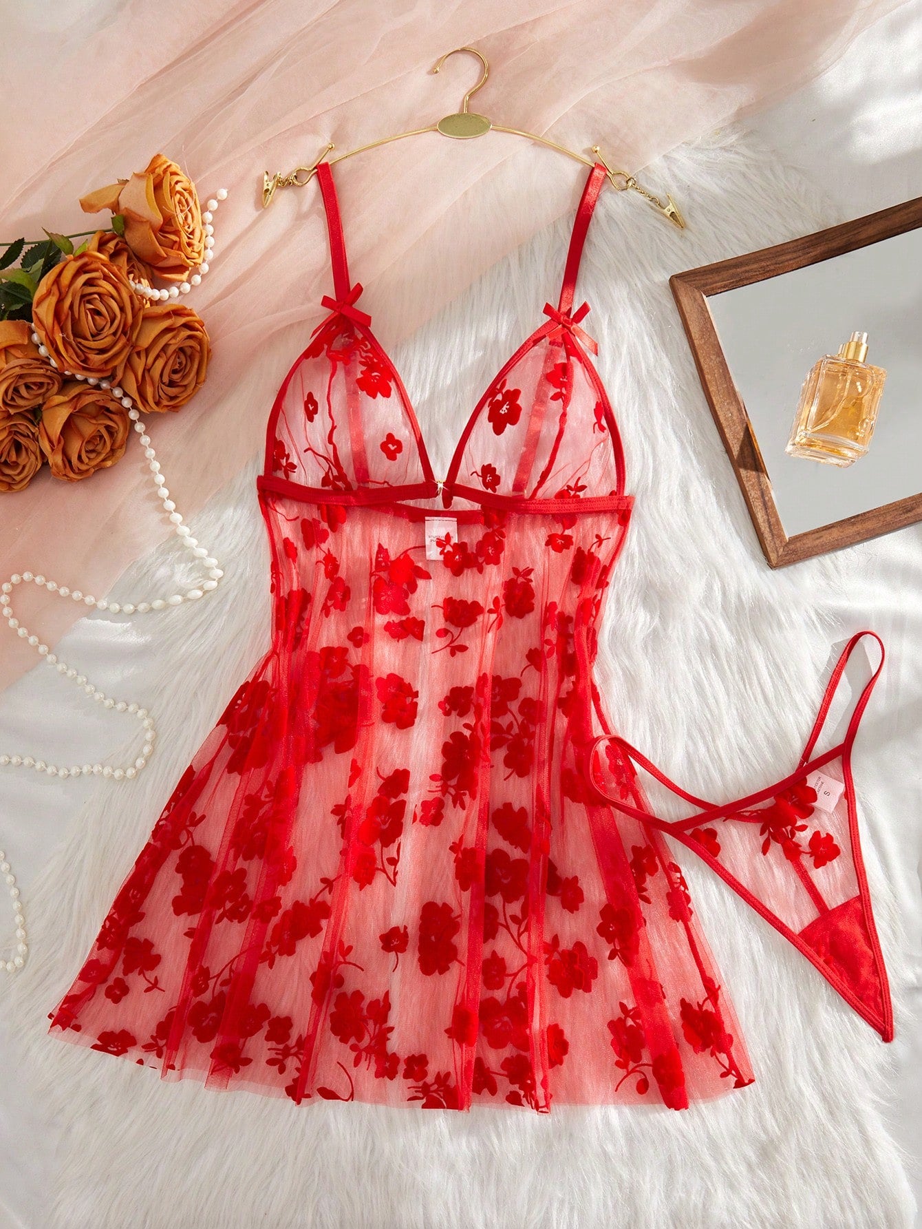 Blue 2-piece women’s lingerie set with floral print mesh and embroidery details, featuring a front-closure spaghetti strap babydoll with adjustable straps and a matching low-rise thong; semi-sheer, sleeveless, and wireless design.
