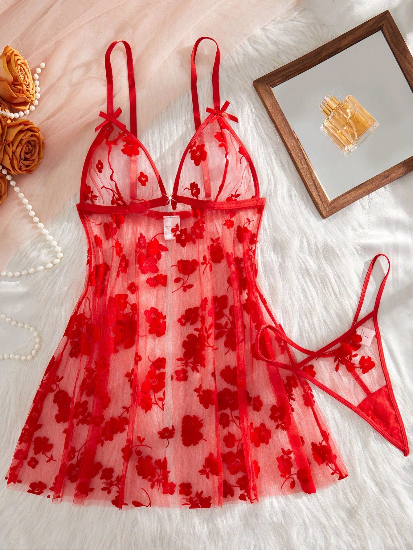 Blue 2-piece women’s lingerie set with floral print mesh and embroidery details, featuring a front-closure spaghetti strap babydoll with adjustable straps and a matching low-rise thong; semi-sheer, sleeveless, and wireless design.