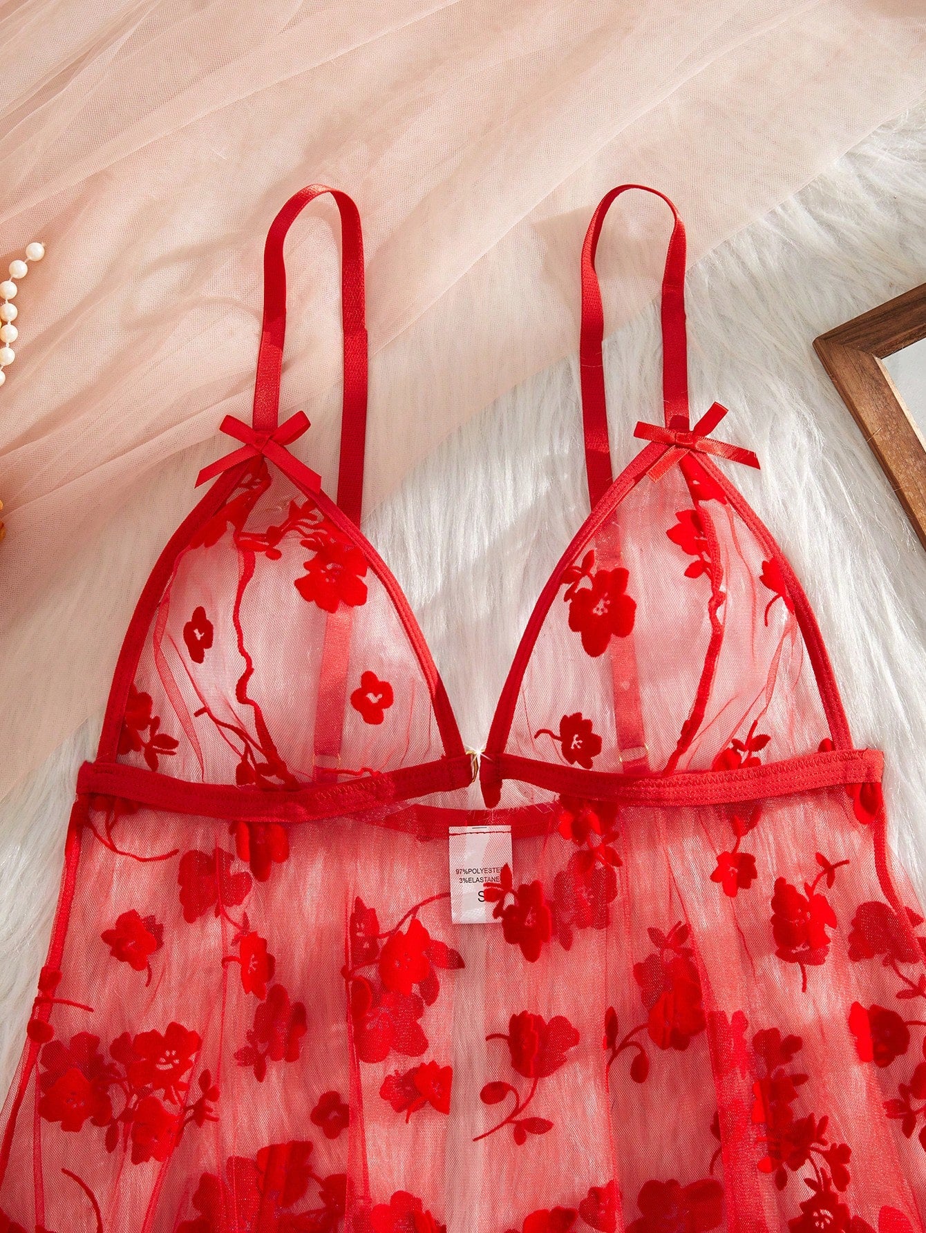 Blue 2-piece women’s lingerie set with floral print mesh and embroidery details, featuring a front-closure spaghetti strap babydoll with adjustable straps and a matching low-rise thong; semi-sheer, sleeveless, and wireless design.