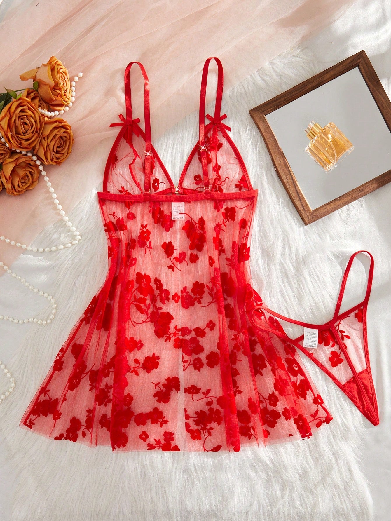 Blue 2-piece women’s lingerie set with floral print mesh and embroidery details, featuring a front-closure spaghetti strap babydoll with adjustable straps and a matching low-rise thong; semi-sheer, sleeveless, and wireless design.