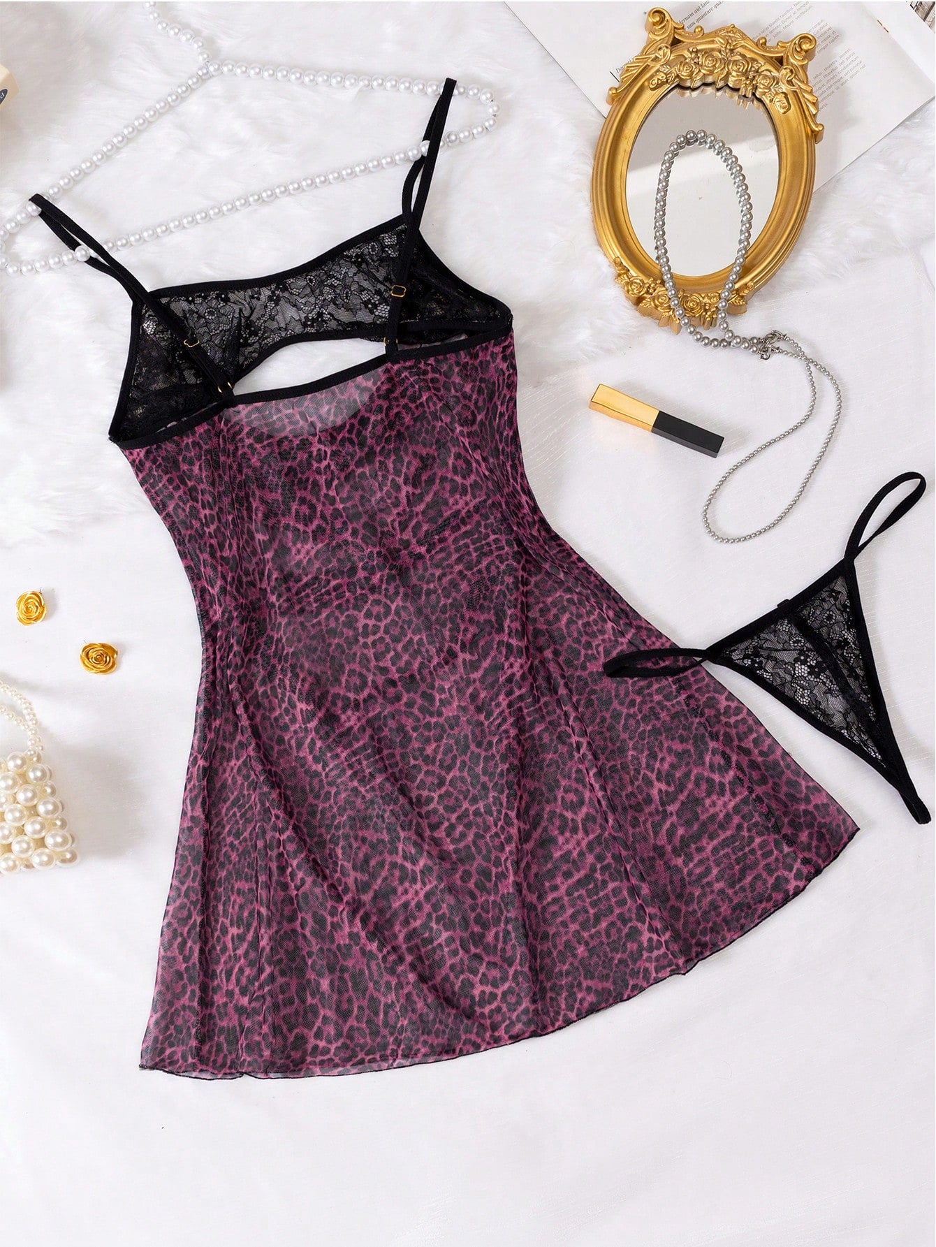 2-piece leopard print lingerie set featuring a hollow-out cami-style short nightgown with adjustable spaghetti straps and a matching low-rise V-string panty.