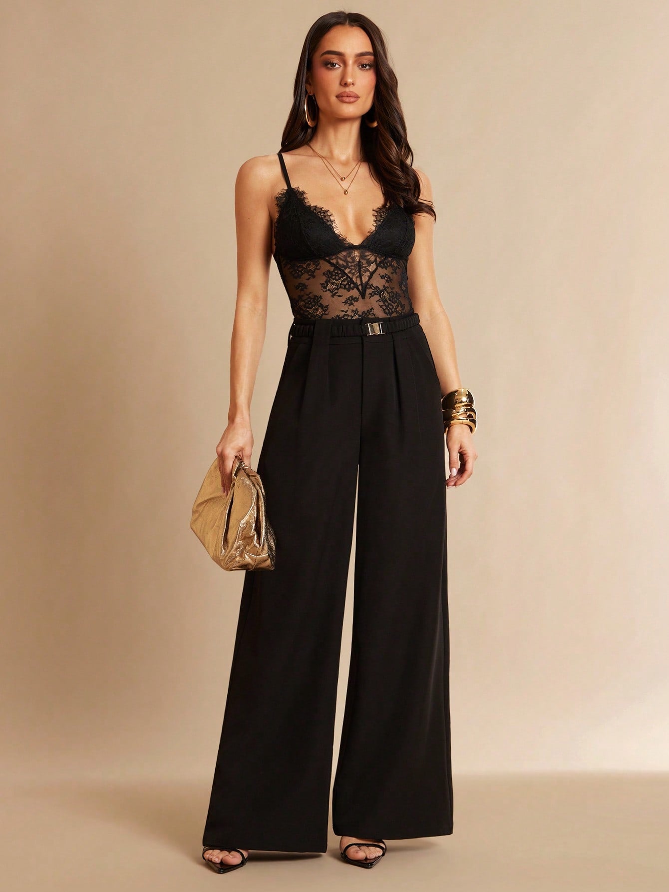 Women's black bodysuit with lace trim, sheer details, backless design, and spaghetti straps in a slim-fit cami style.