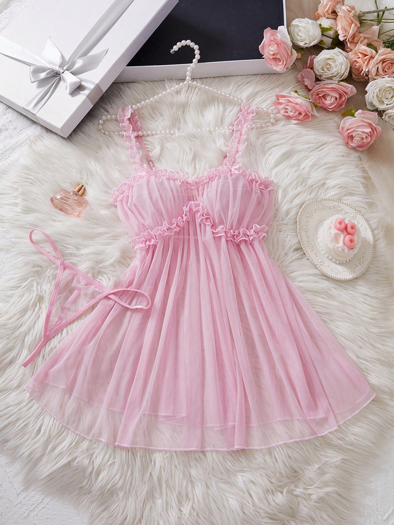 Women’s semi-sheer mini slip nightgown with adjustable spaghetti straps, sweetheart neckline, contrast lace, bow and frill details, and a matching low-rise V-string in a 2-piece set.