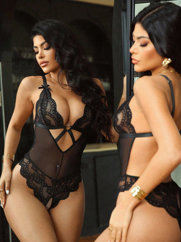 Women’s one-piece lace bodysuit with patchwork design, criss-cross detail, cut-out accents, spaghetti straps, and a semi-sheer look.