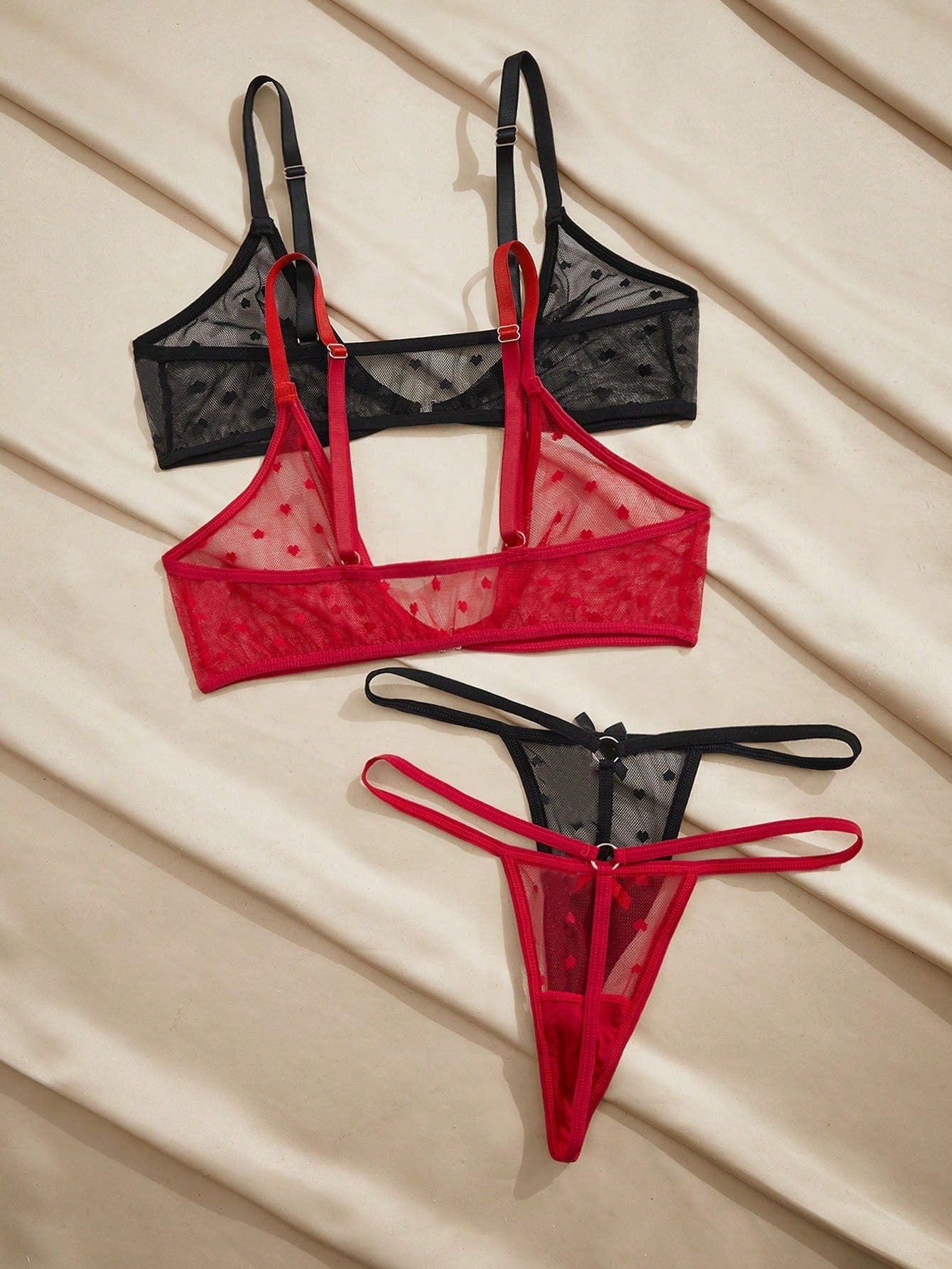Women's heart mesh lingerie set with sheer plant pattern and bow detail, featuring a wireless bralette with adjustable straps and a matching low-rise thong.