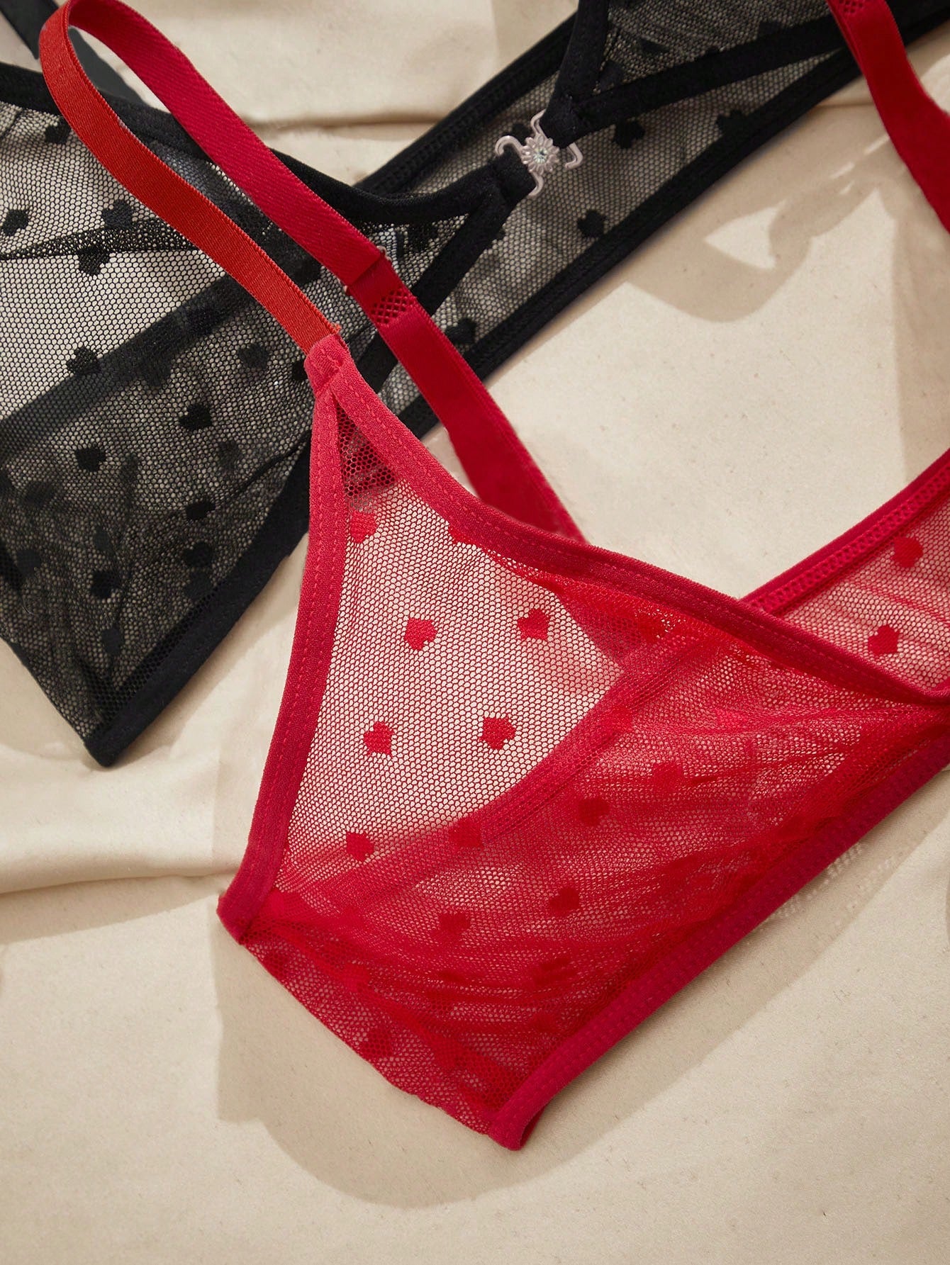 Women's heart mesh lingerie set with sheer plant pattern and bow detail, featuring a wireless bralette with adjustable straps and a matching low-rise thong.