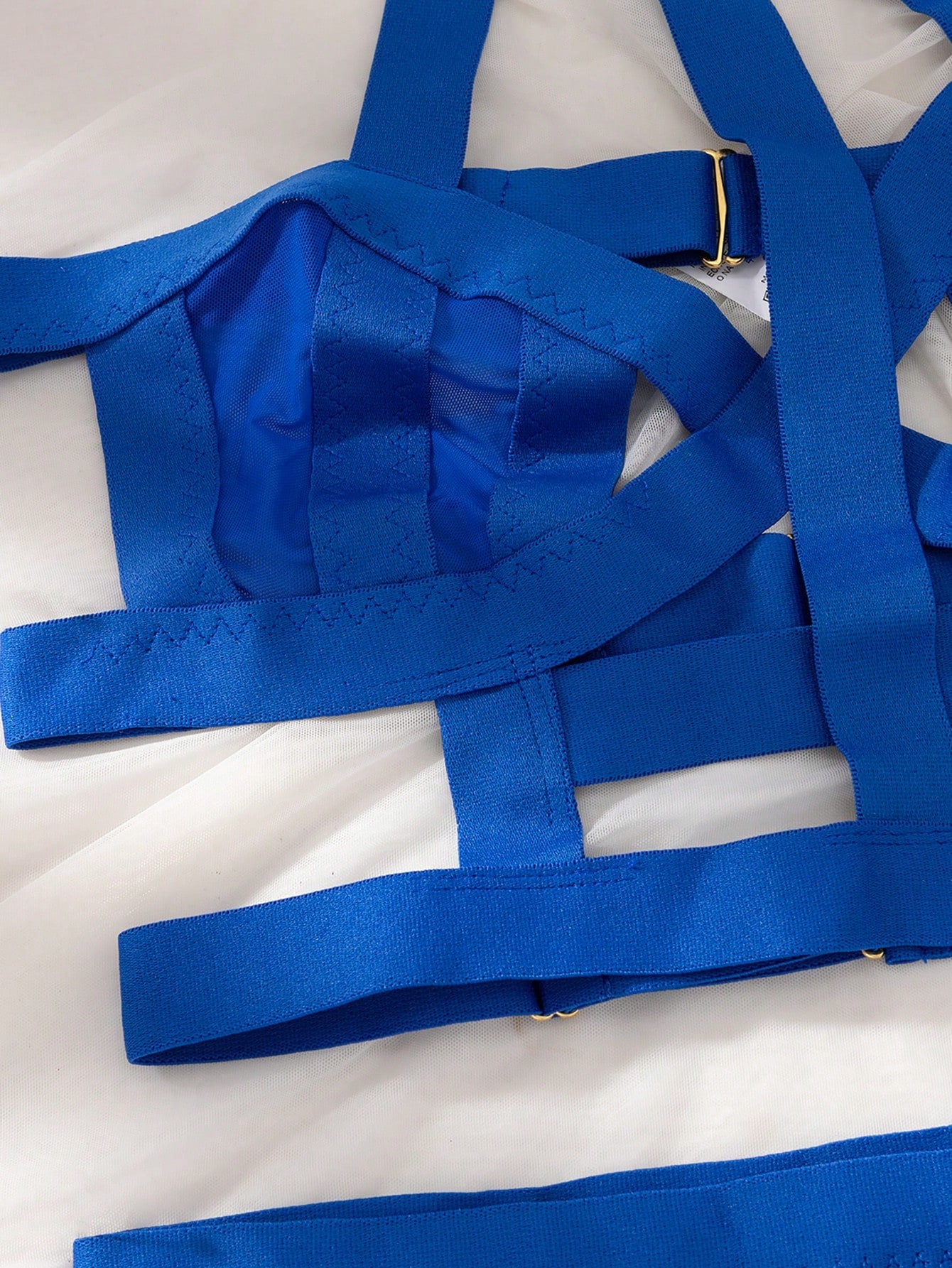 Women’s 4-piece solid cut-out garter lingerie set with halter bralette and thong, includes 1 pair of leg rings; plain ultra-sexy style in slight-stretch fabric, available in red and royal blue.