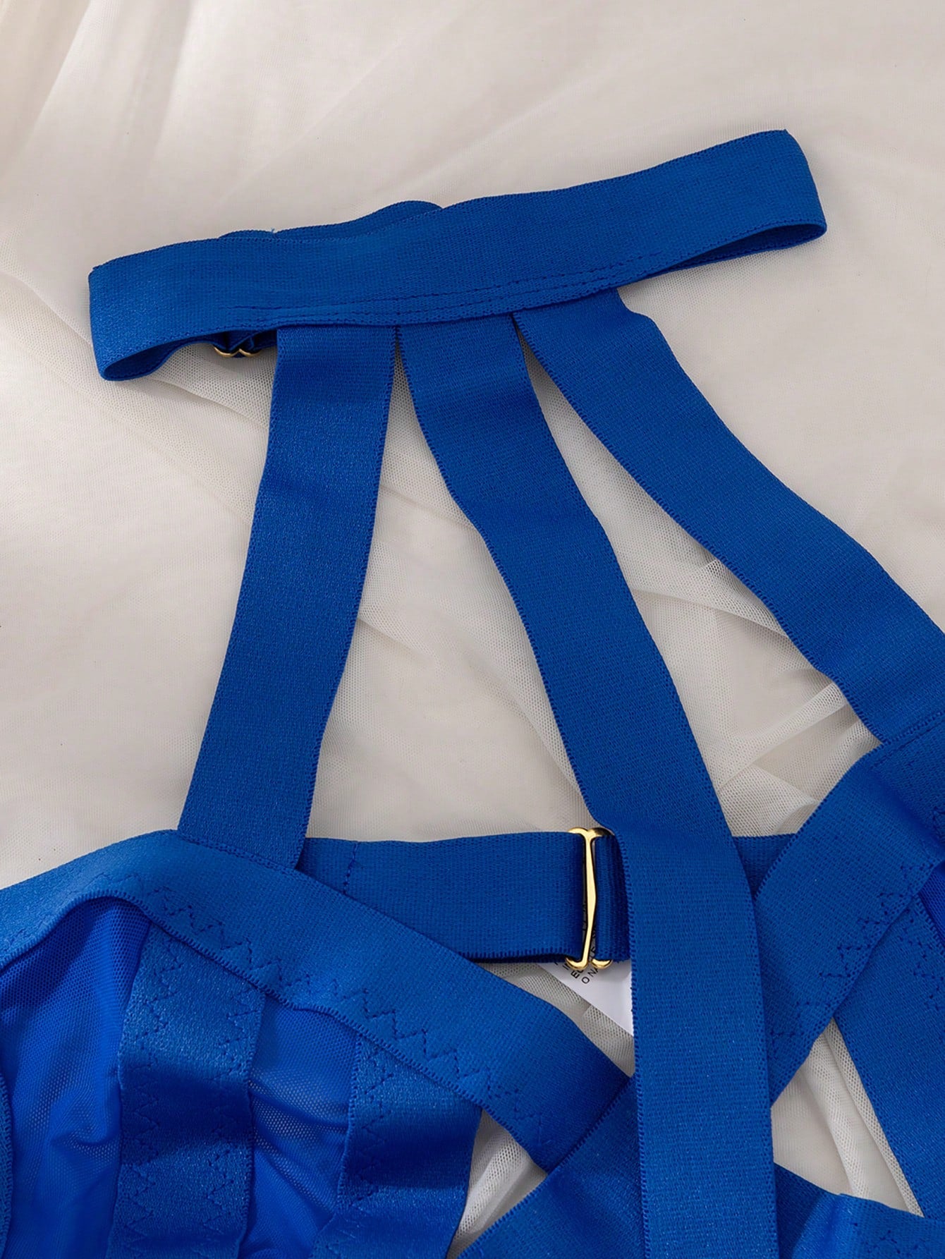 Women’s 4-piece solid cut-out garter lingerie set with halter bralette and thong, includes 1 pair of leg rings; plain ultra-sexy style in slight-stretch fabric, available in red and royal blue.