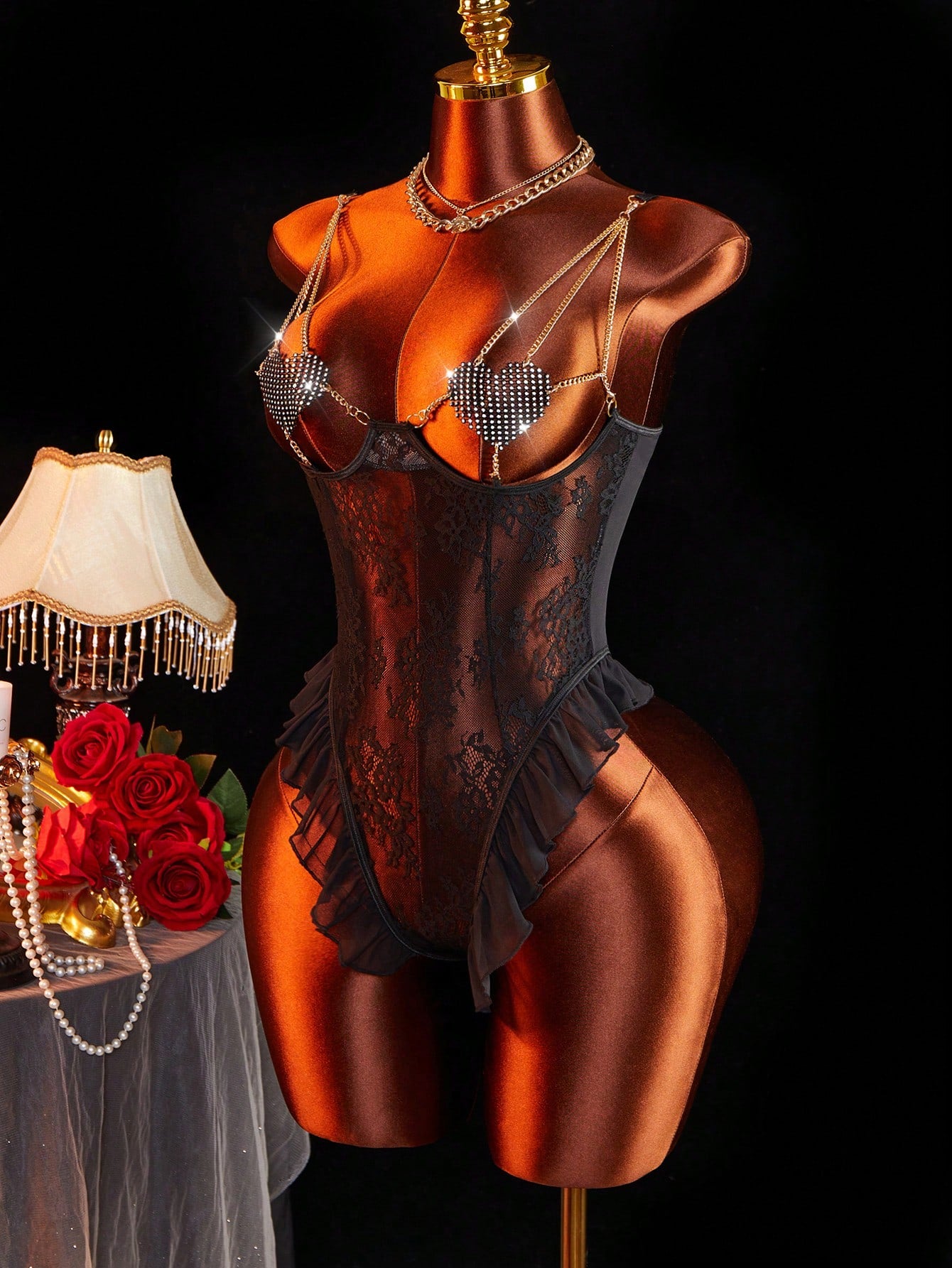 Women’s sexy lingerie bodysuit featuring semi-sheer contrast lace, adjustable spaghetti shoulder straps, heart decor detail, and a ruffle lace crotchless jumpsuit design.