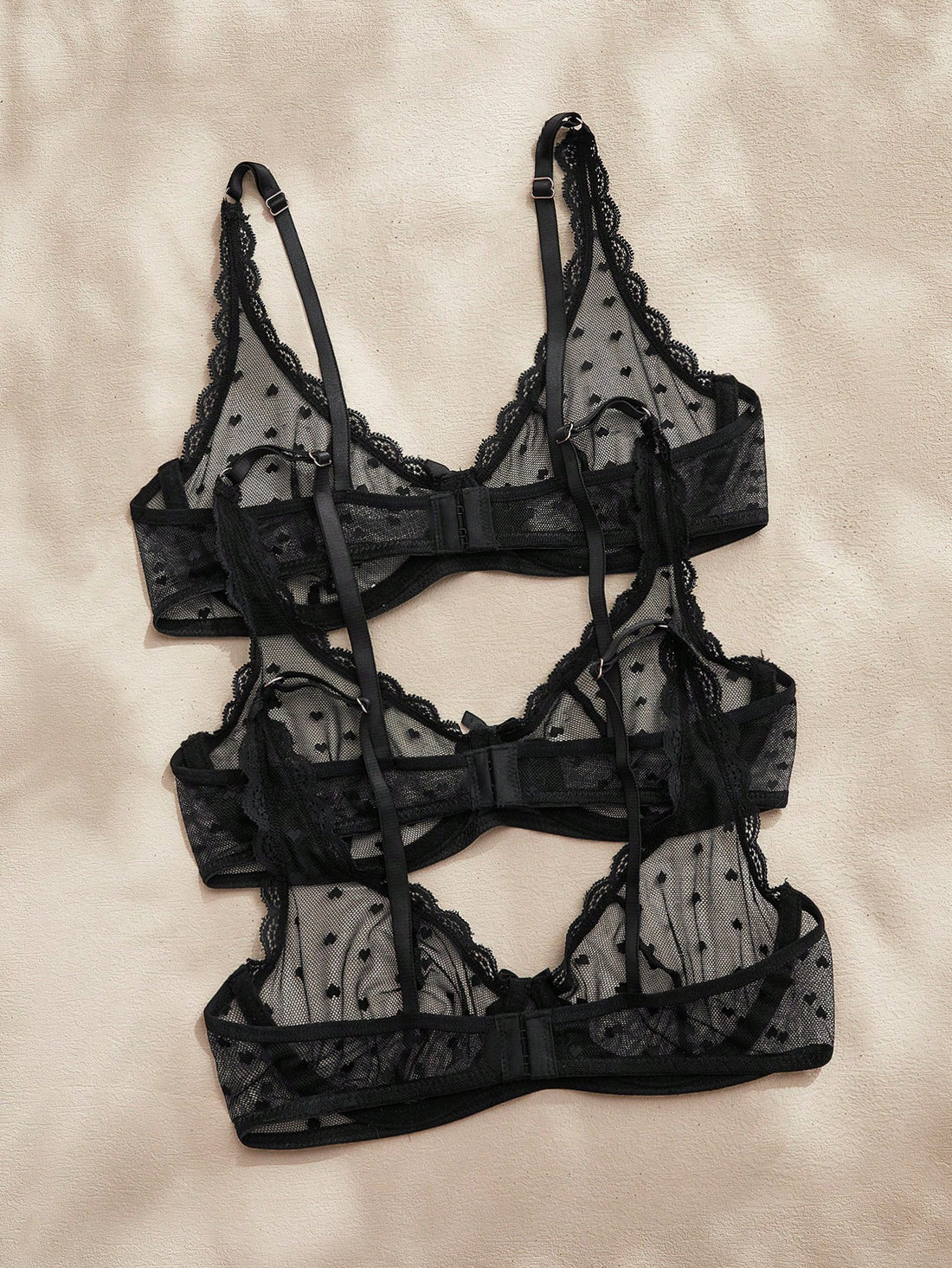 Women's solid color lace bra with sheer unlined design, bow detail, underwire support, and adjustable straps; romantic style push-up bralette for daily wear.