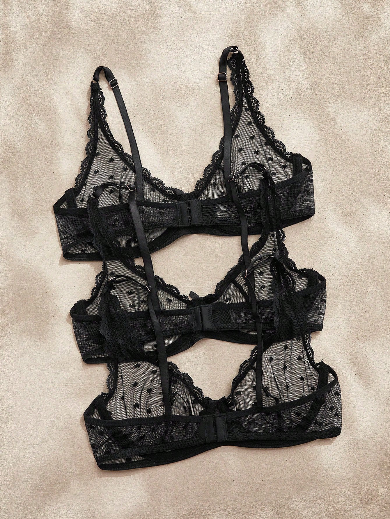 Women's solid color lace bra with sheer unlined design, bow detail, underwire support, and adjustable straps; romantic style push-up bralette for daily wear.