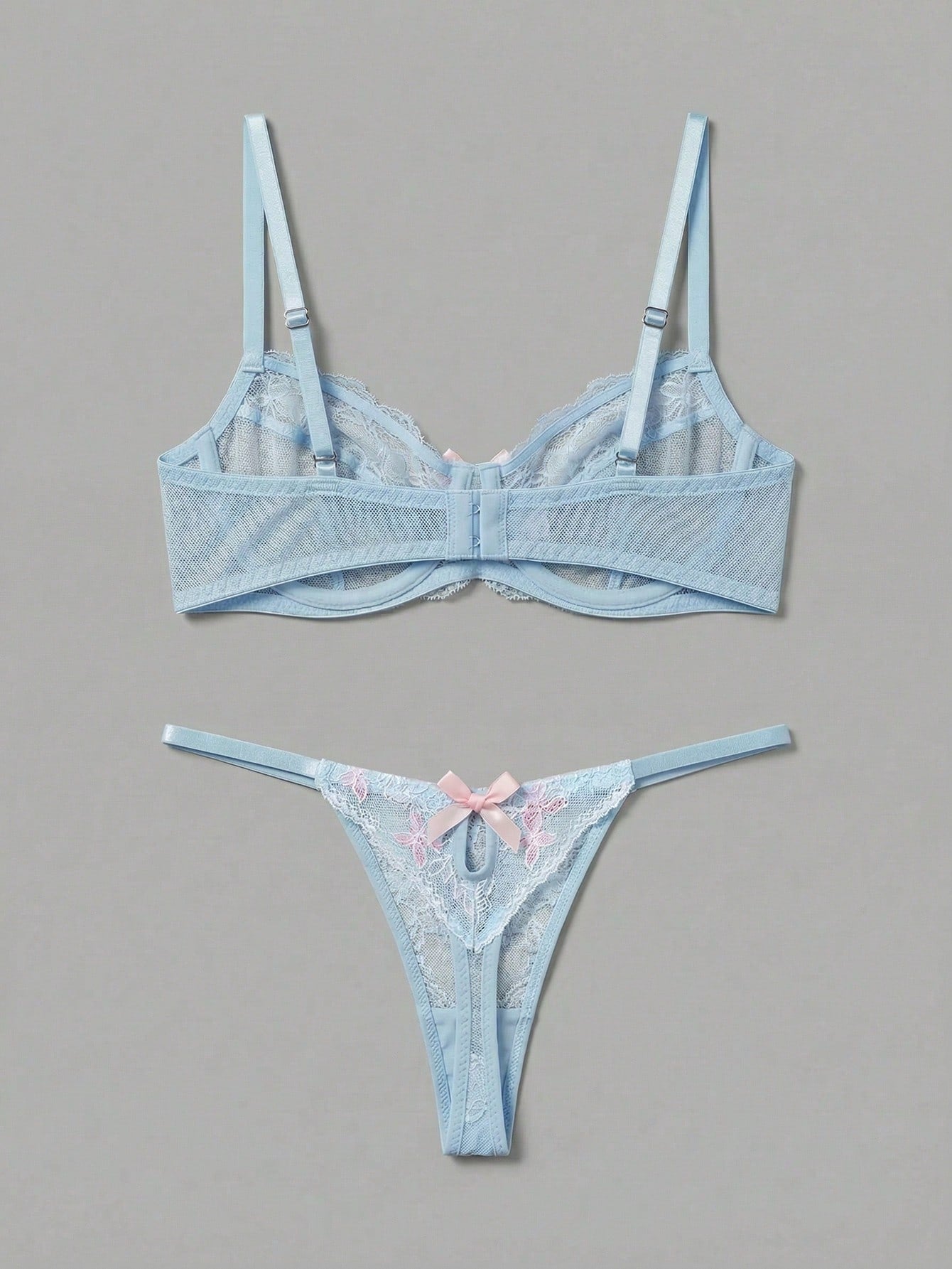 Two-piece pink lingerie set featuring a sheer mesh underwire bra with floral embroidery and adjustable straps, paired with a matching low-rise thong.