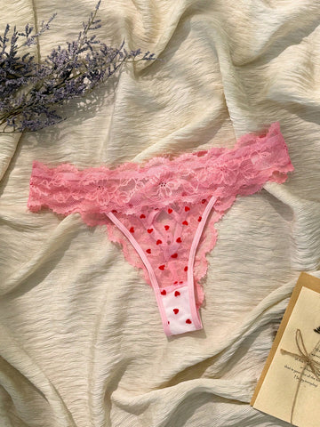 Women's pink heart flocked thong panties with sheer detailing, lace trim, geometric pattern accents, and a mid-rise romantic-floral style.
