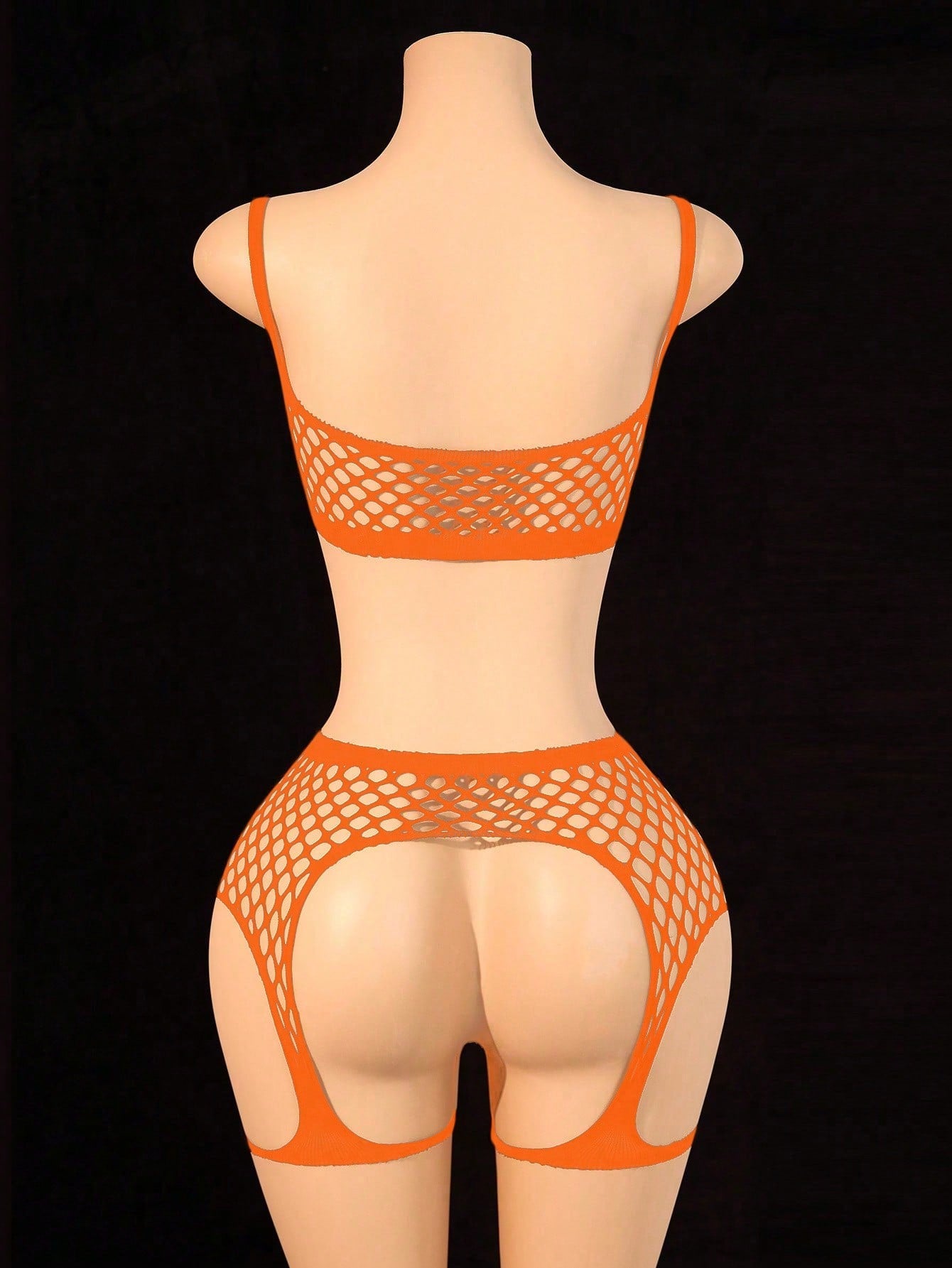 Black 2-piece fishnet lingerie set featuring a sheer wireless bralette with spaghetti straps and matching mini shorts with hollow-out detail; high-stretch fabric in a plain pattern.