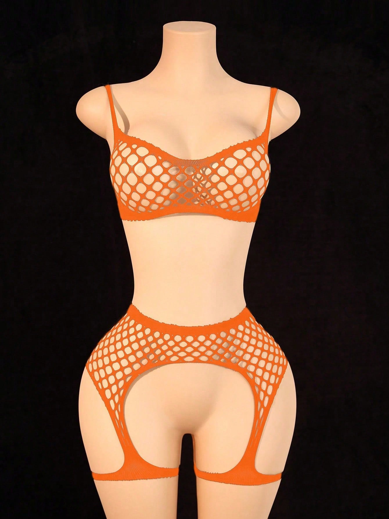 Black 2-piece fishnet lingerie set featuring a sheer wireless bralette with spaghetti straps and matching mini shorts with hollow-out detail; high-stretch fabric in a plain pattern.